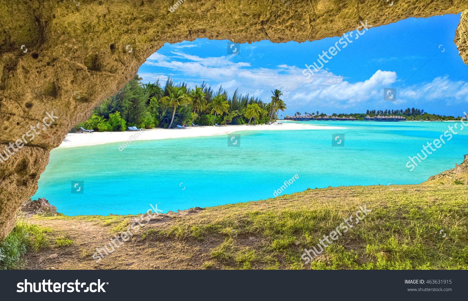 Panoramic view through cave of natural sea beach under summer blue sky  travel holiday concept