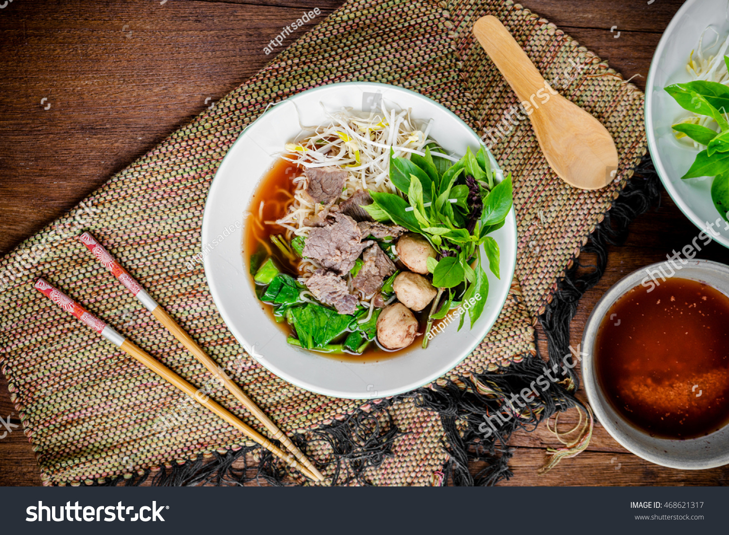 asian noodle soup with beef meatball with fresh vegetable on wood table vintage style street food hot and spicy noodle soup asian food. Top view