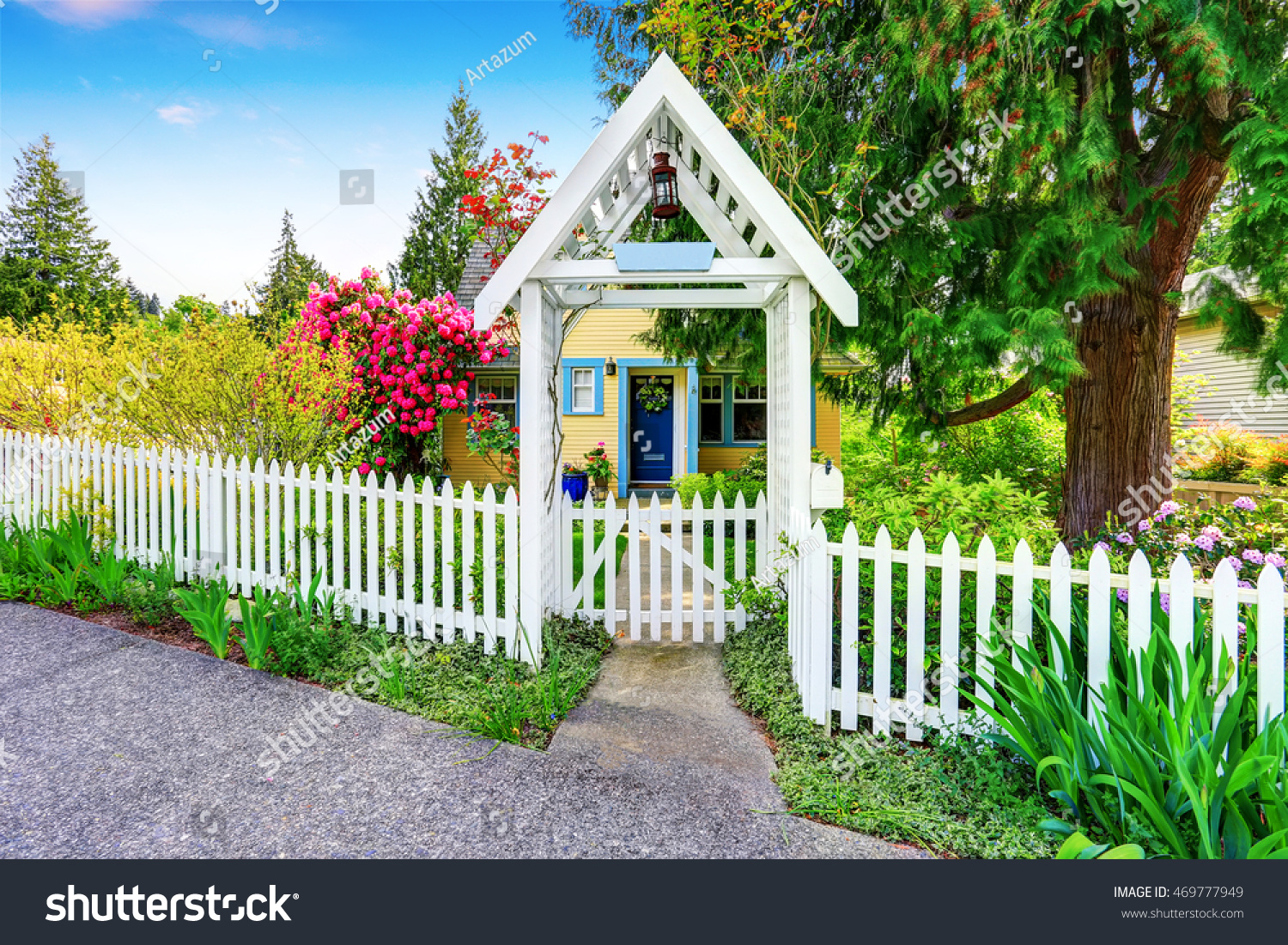 Small Yellow house exterior with White picket fence and Decorative Gate ...
