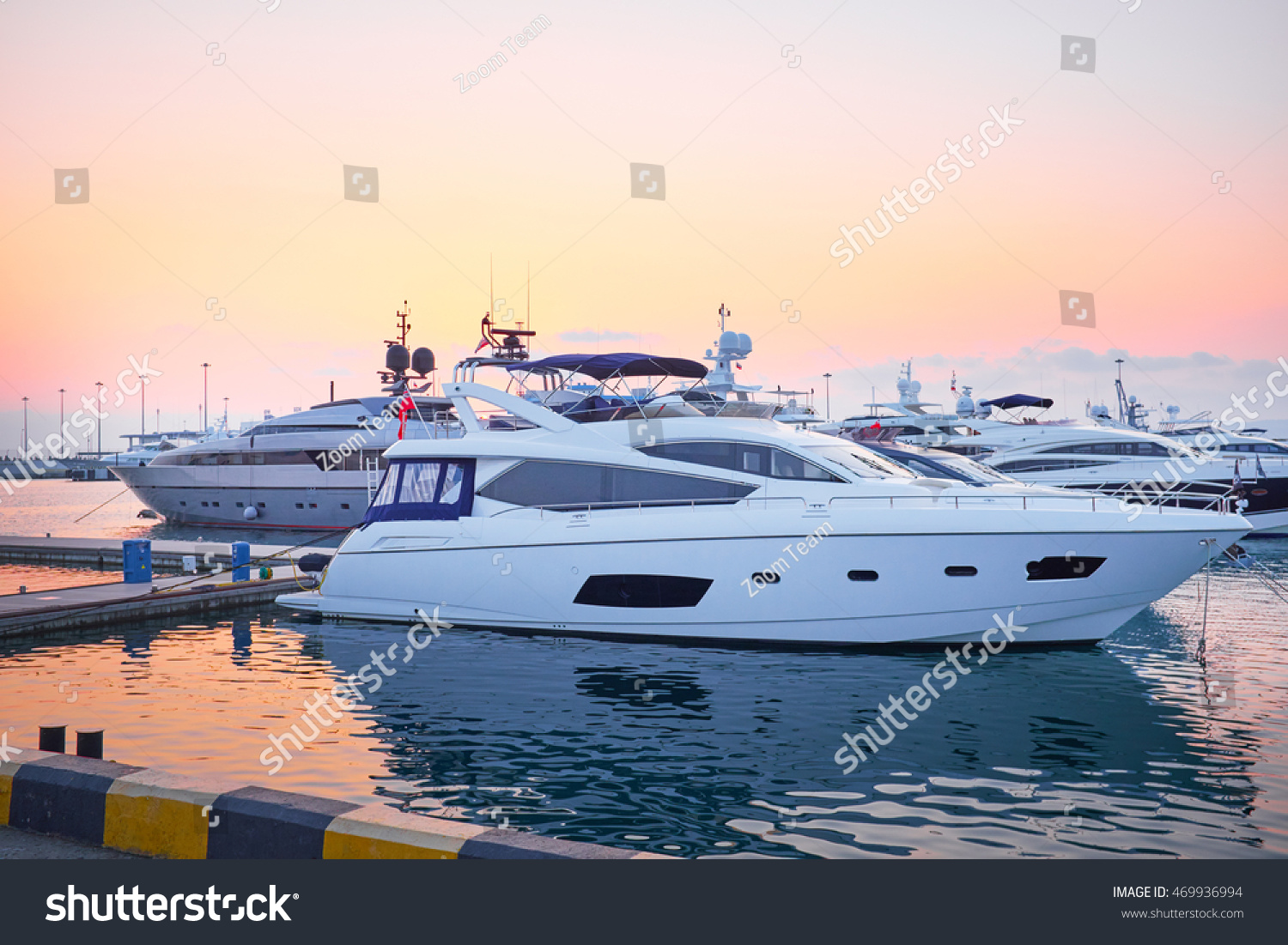 Extra Large Luxury yachts rest in the port at sunset