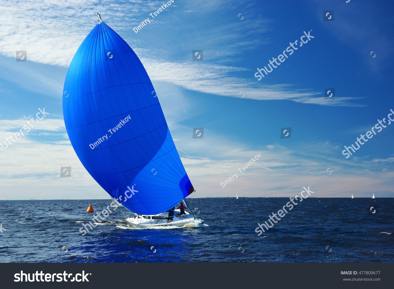 Sailing yacht race. Yachting. Boat with big blue spinnaker sail.