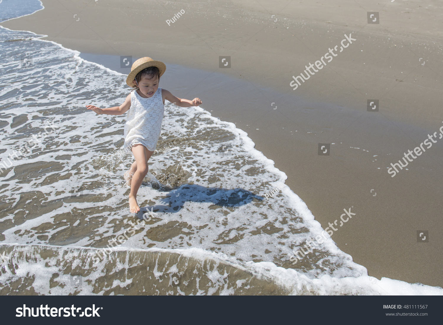Happy Little Girl Playing at the beach