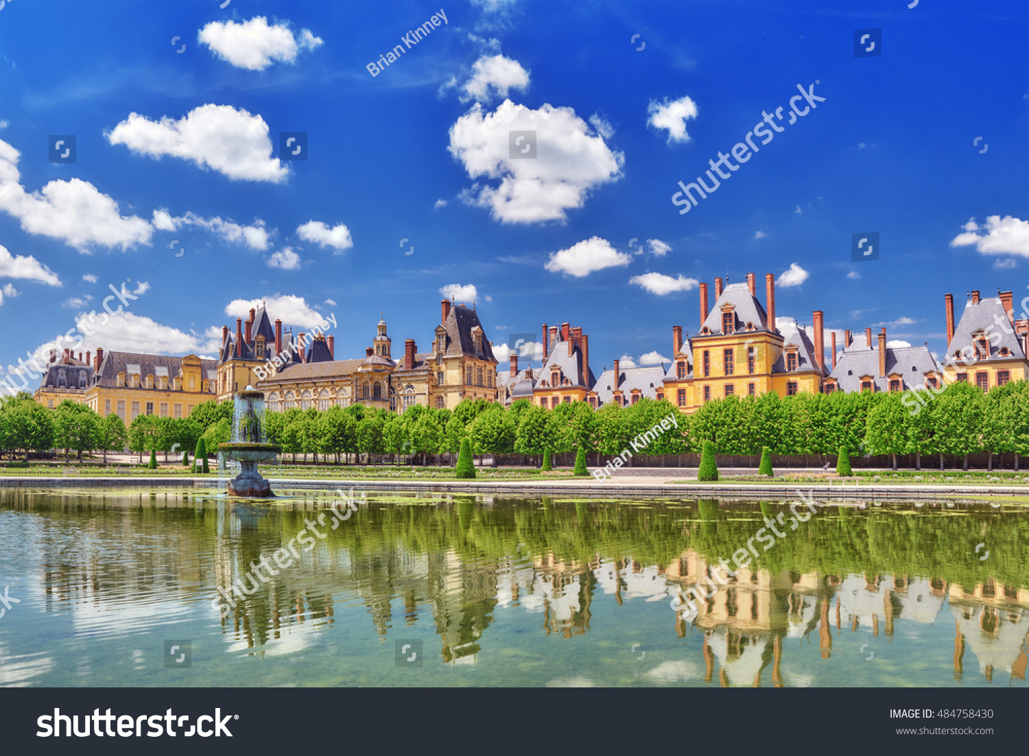 Suburban Residence of the France Kings - beautiful Chateau Fontainebleau with the fountain on foreground.