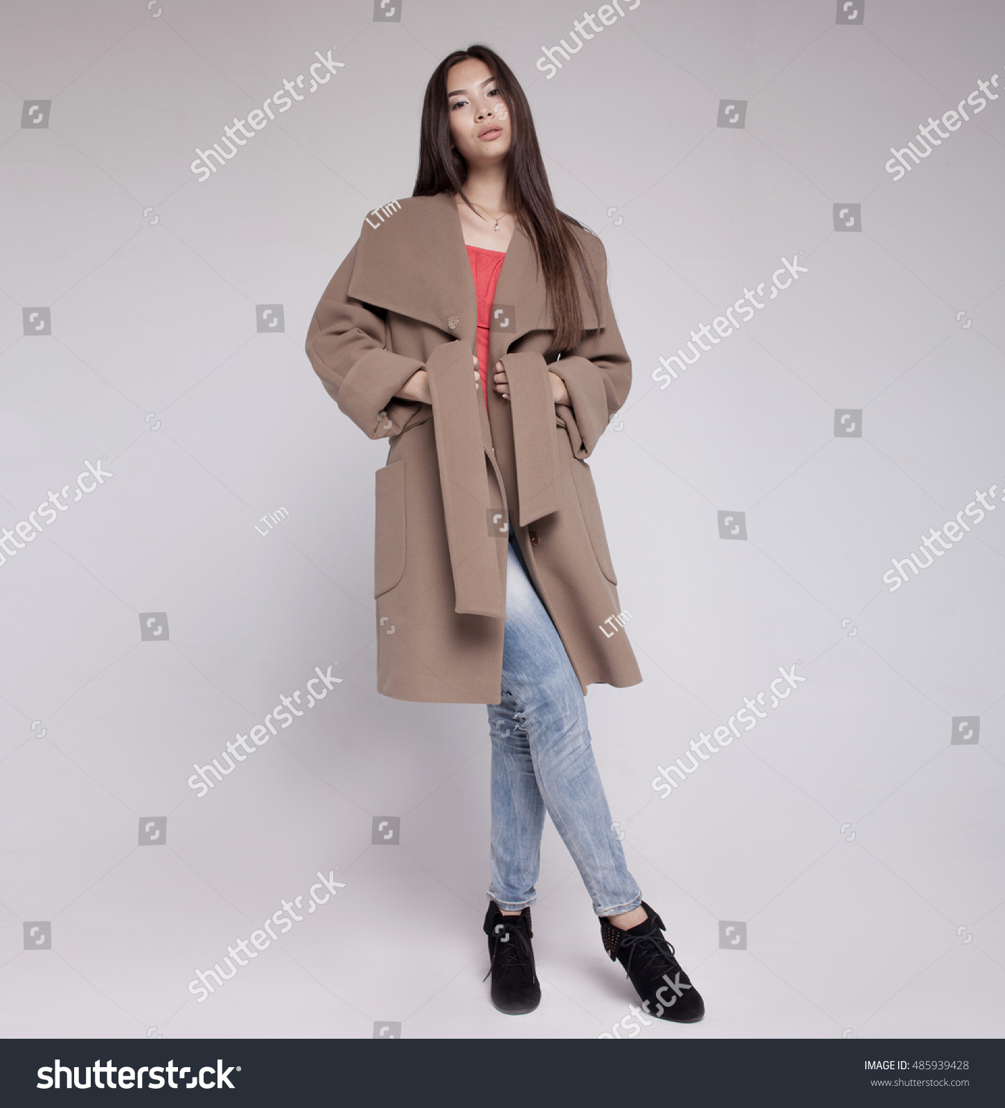 fashion asian model in autumn/winter clothes posing in light background