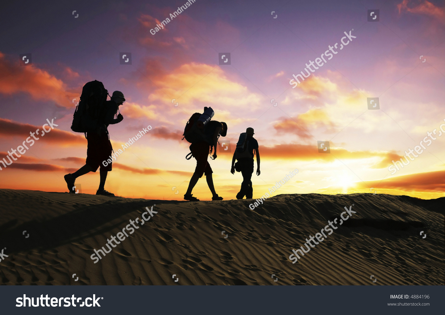 Group going along hill on sunset