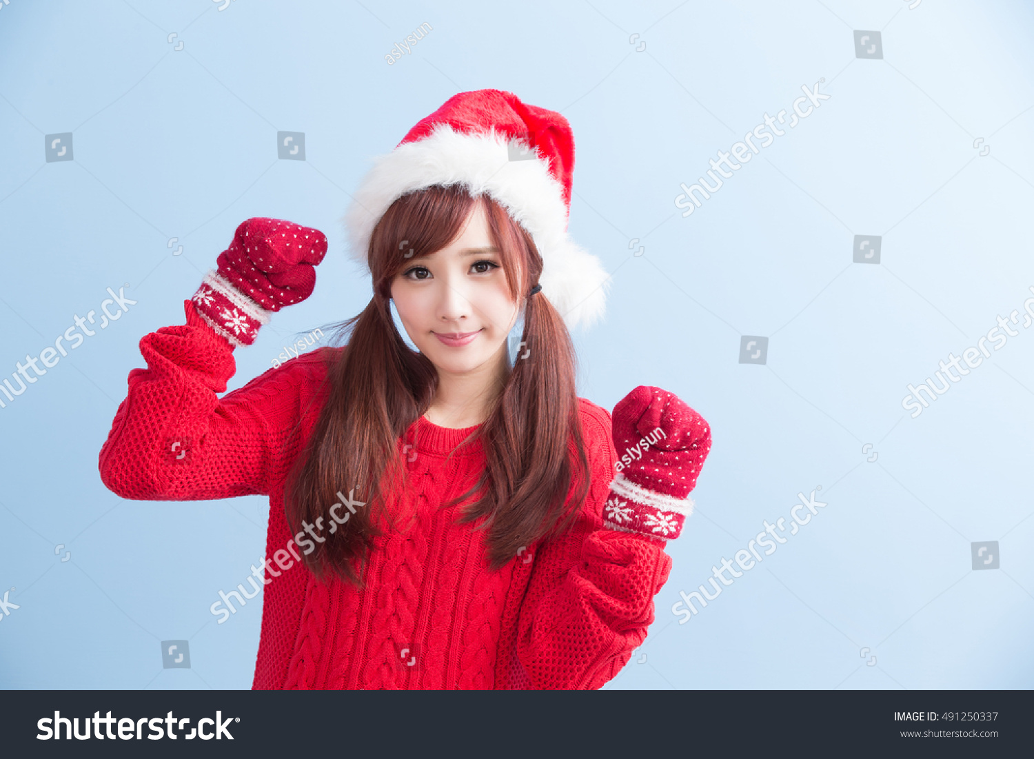 Happy Christmas beauty woman wears red shirt isolated on blue background  asian