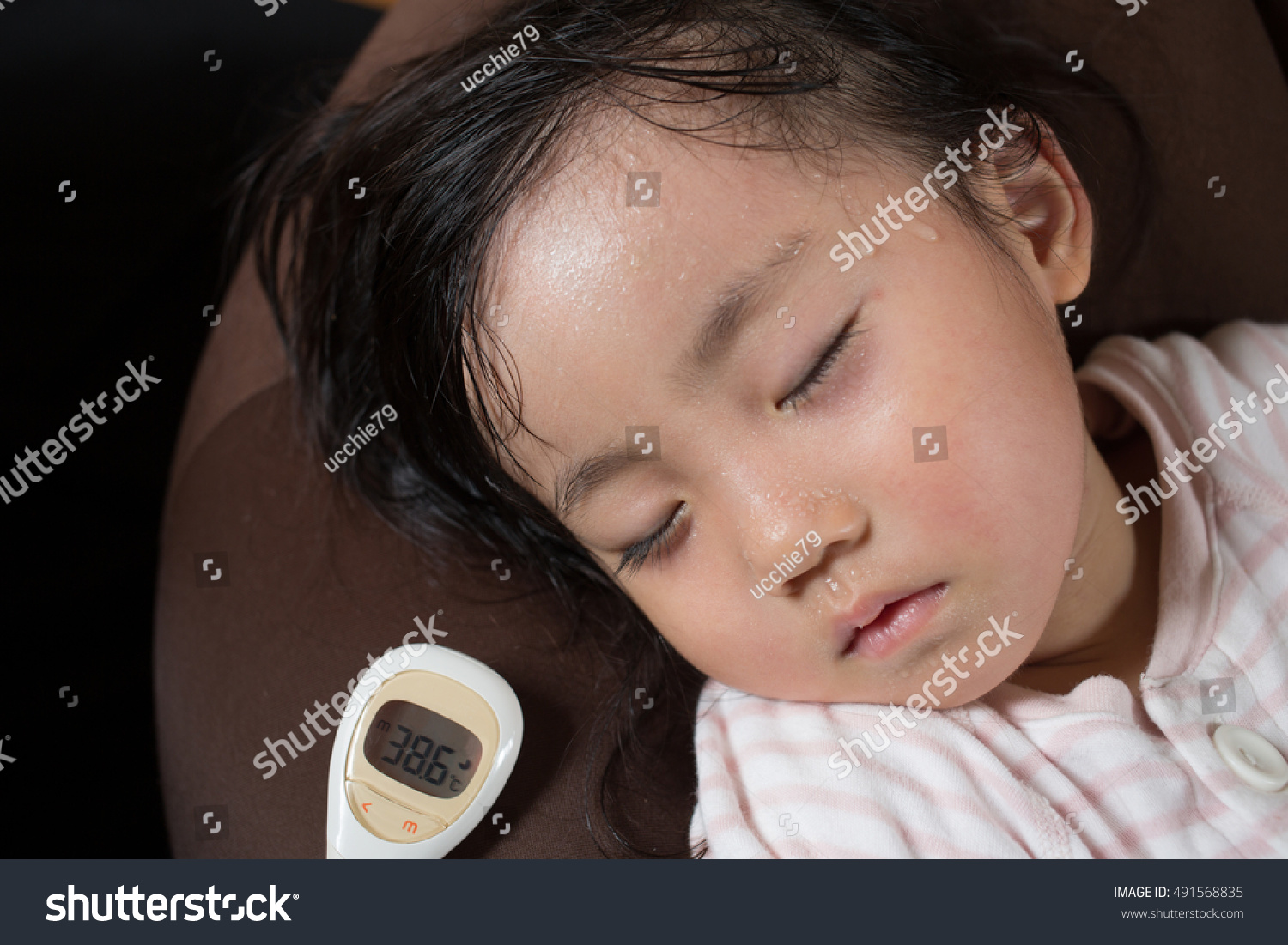 asian little girl gets high fever