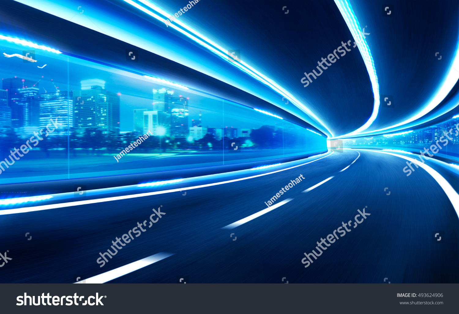 Abstract blurred speed motion road in glass tunnel over the city