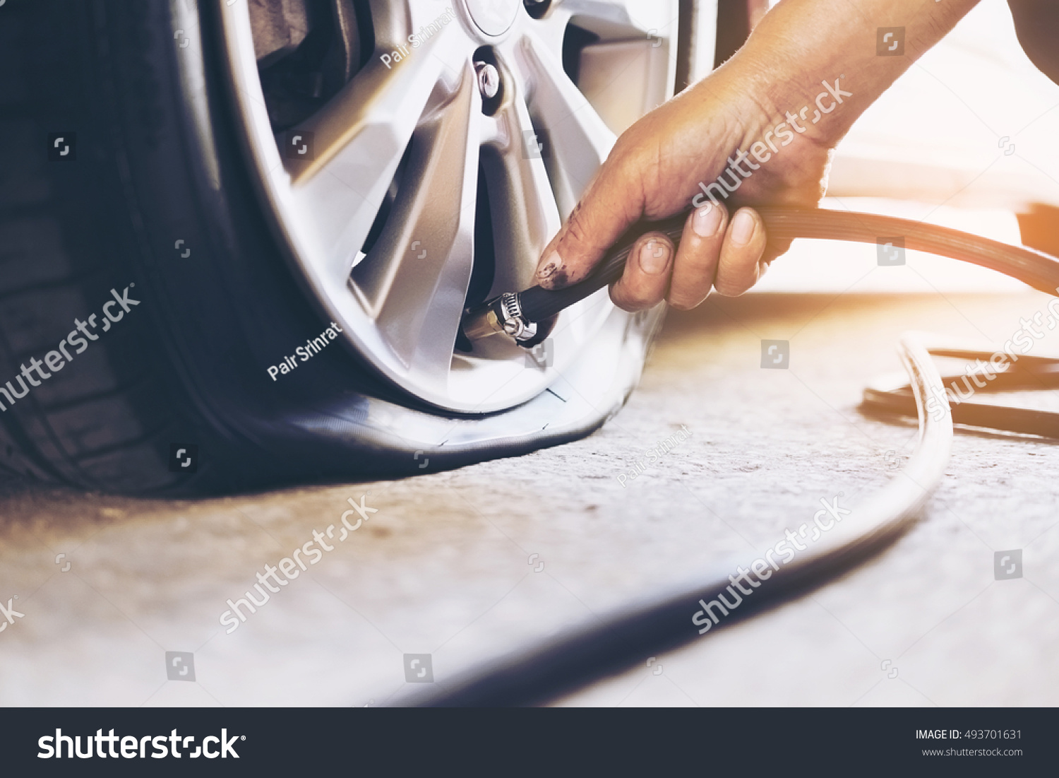 Technician is repairing car flat tire