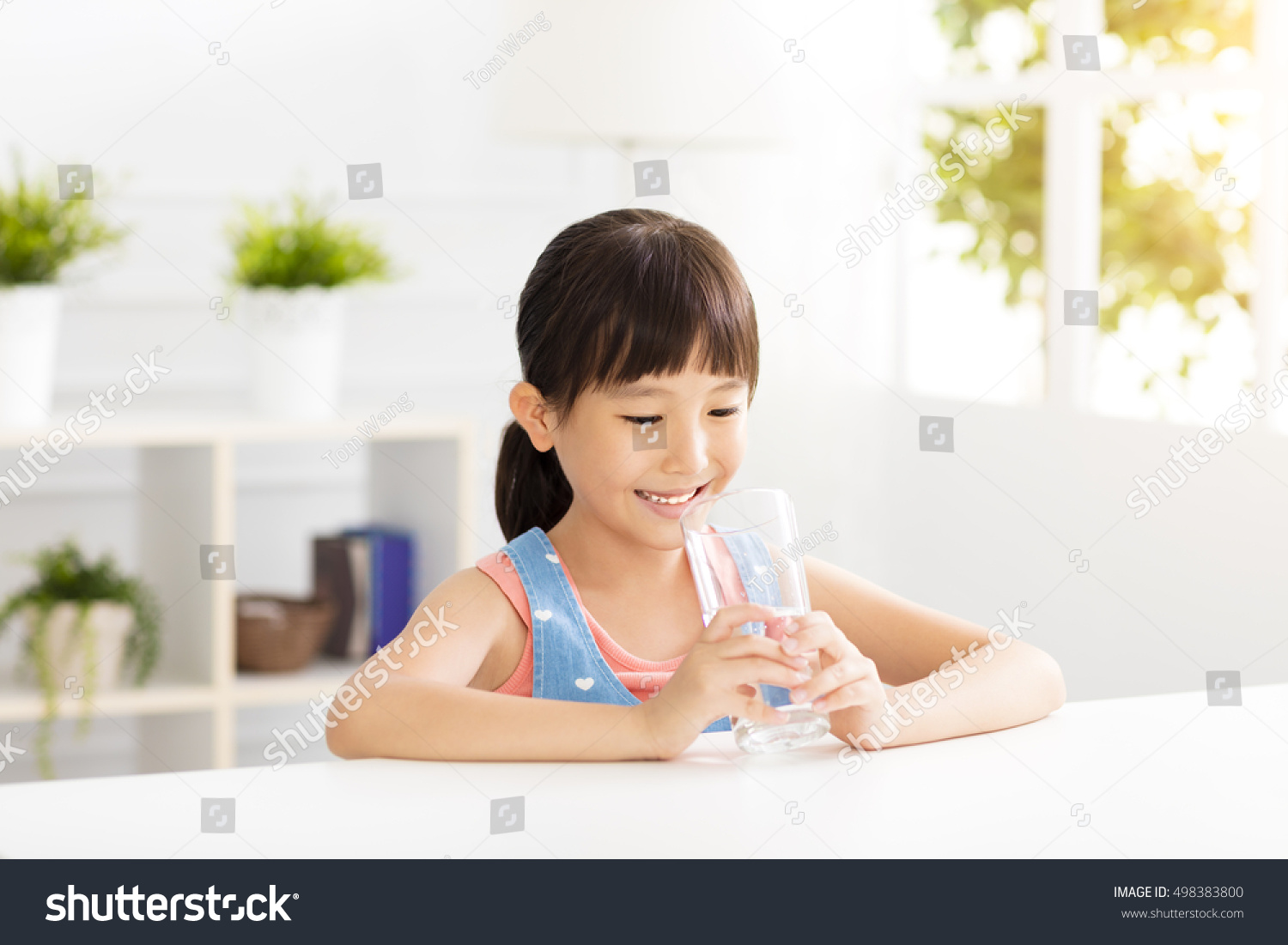 happy Child drinking water from glass