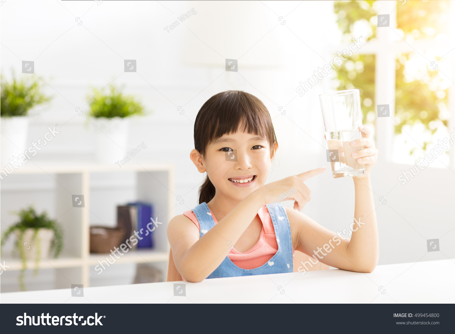 happy Child drinking water from glass
