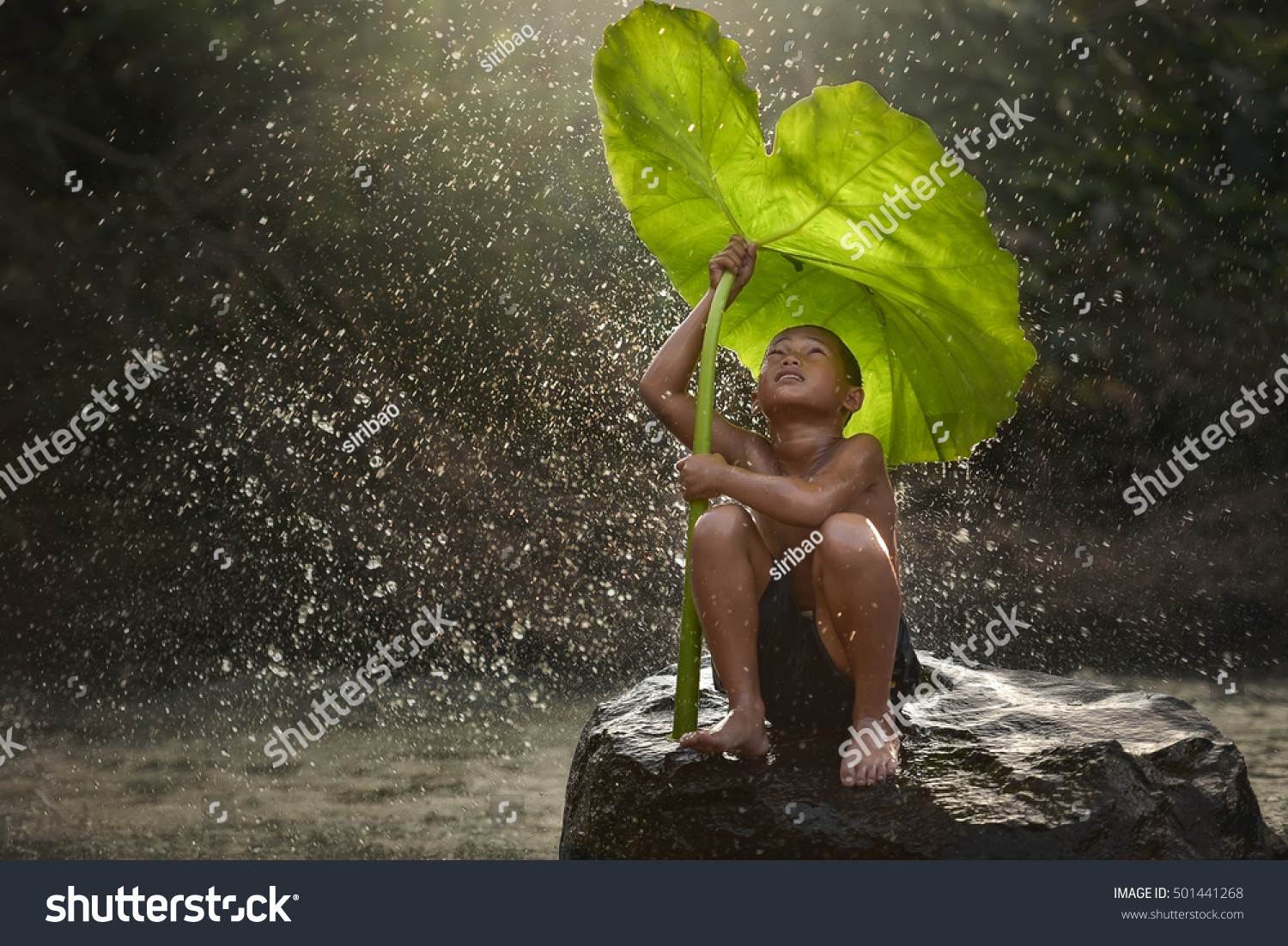 The people joy of a country boy local in laos  with nature Boy waiting for rain..