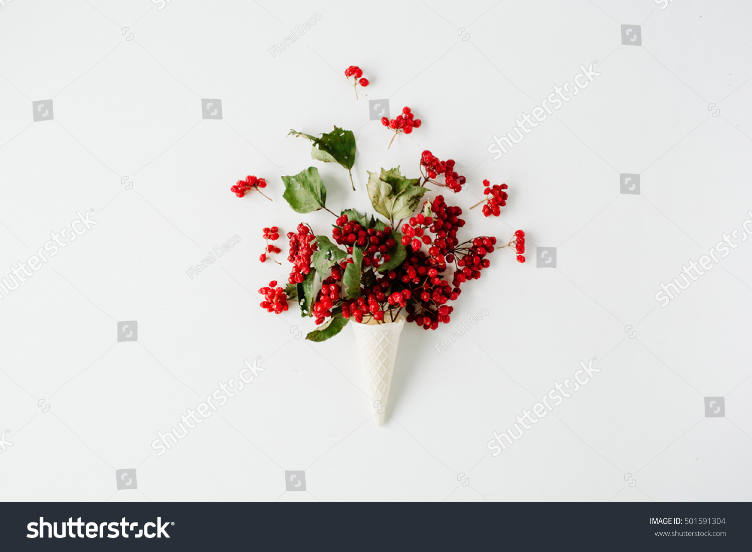ice cream waffle cone with red rowan bouquet on white background flat lay top view. autumn wallpaper