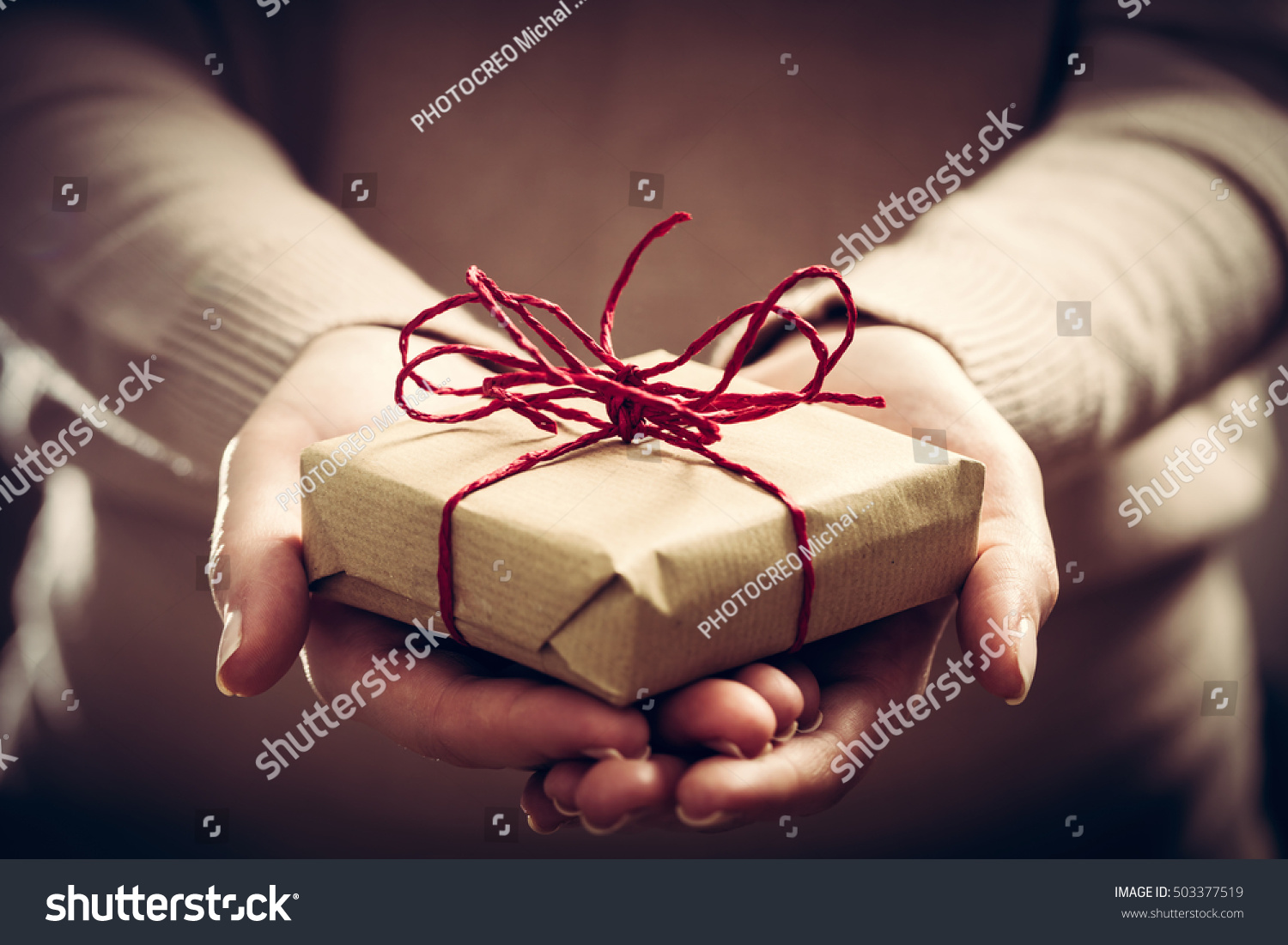 Giving a gift  handmade present wrapped in paper. Christmas time  vintage mood.