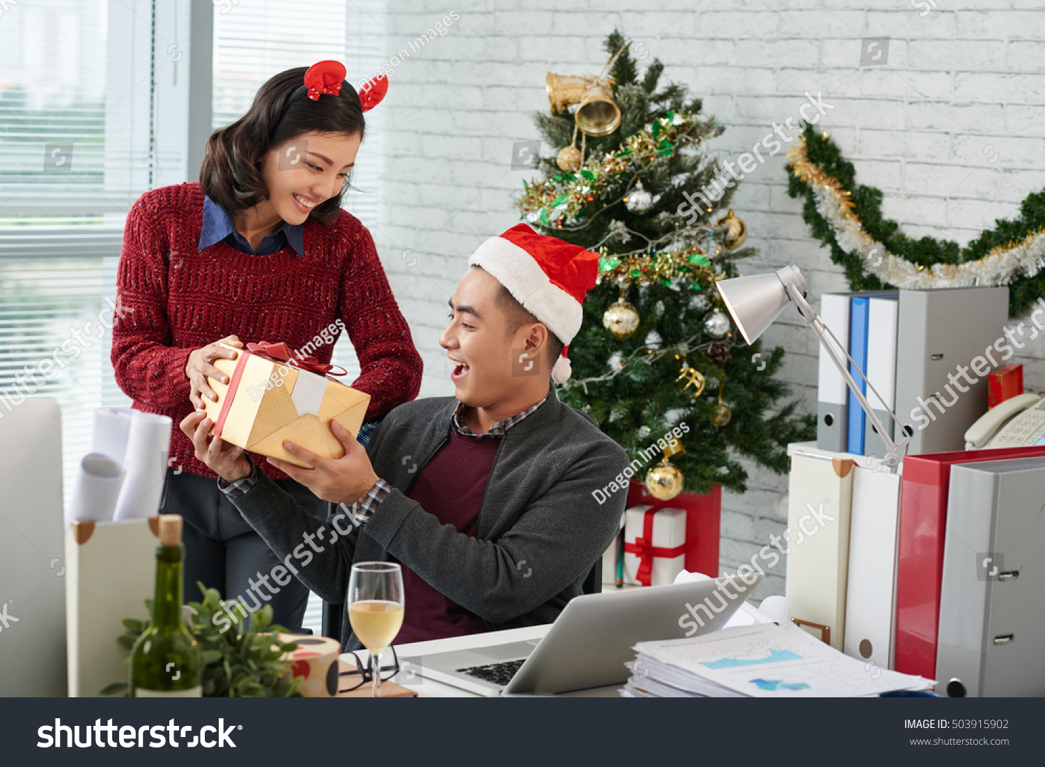 Businessman excited to receive a gift from his female coworker