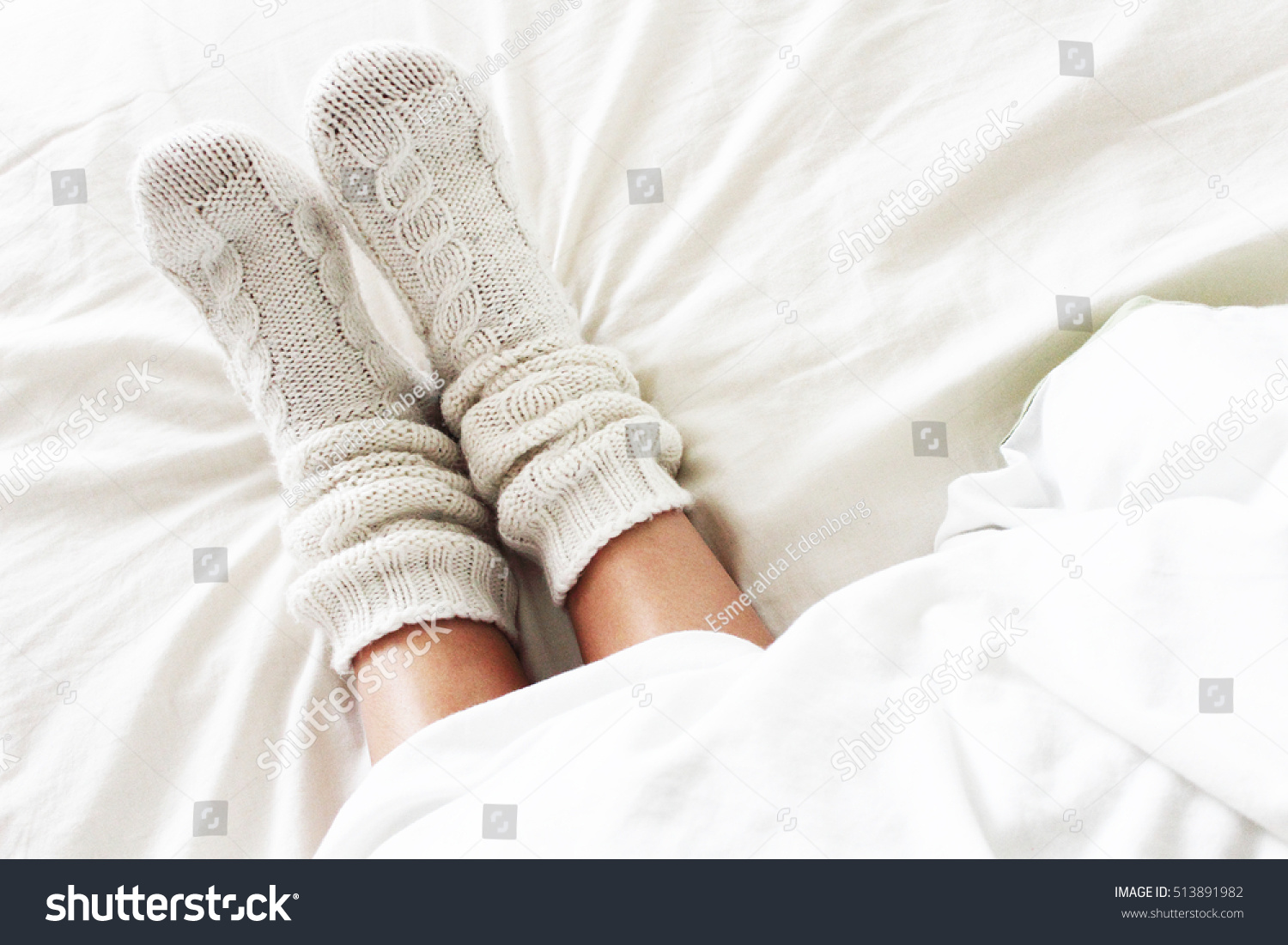 Warm and cozy white socks in the bed