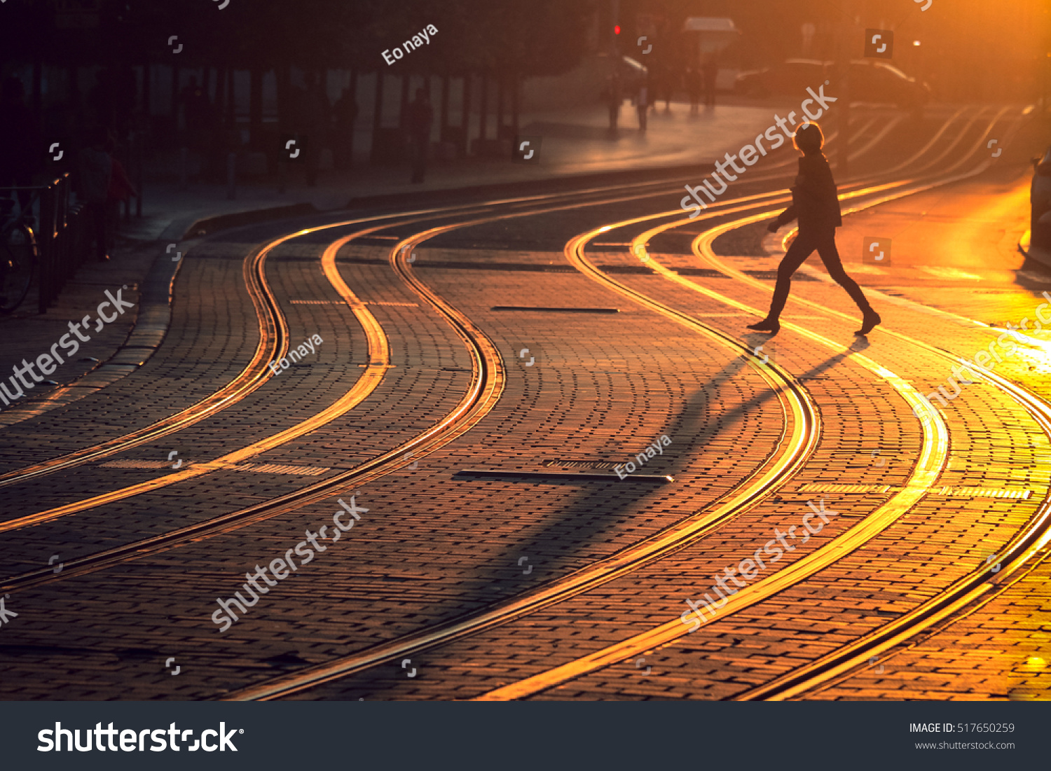 Street photography of blurred woman walking on tram railway during the sunset in Bordeaux city  France.  Vintage style and grain texture 