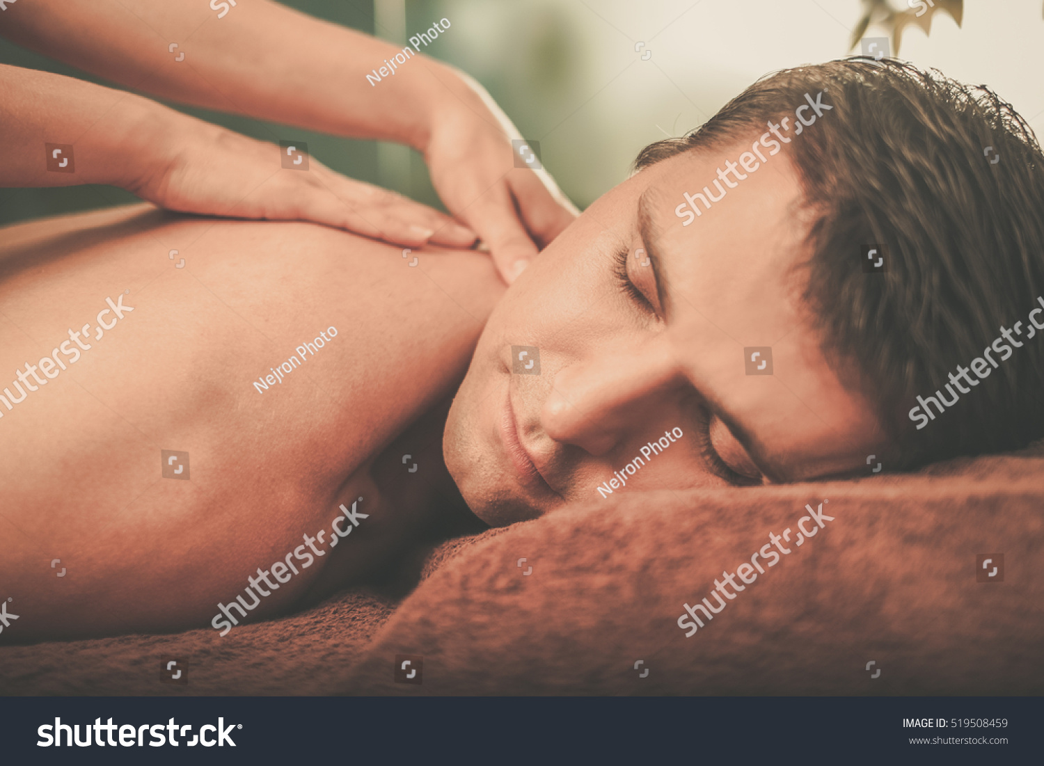 Handsome man having massage in spa salon