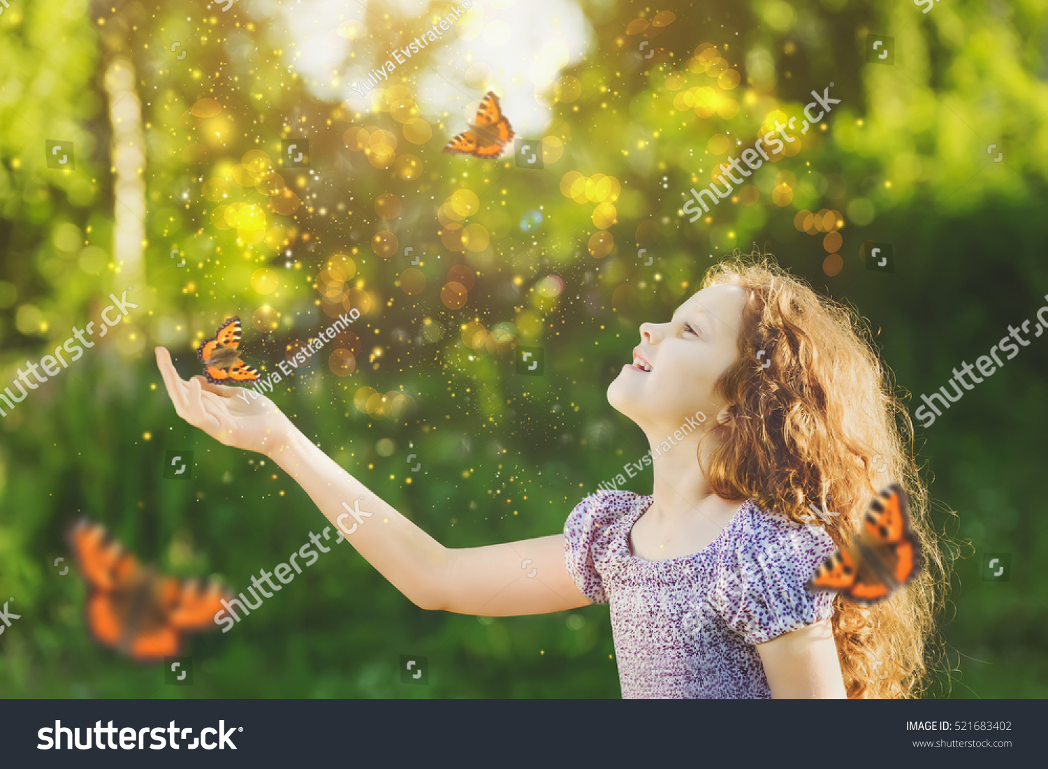 Laughing cute child with a butterfly on his nose and hands. Fairy dreams for princess girl. Happy childhood concept. Toning instagram filter.