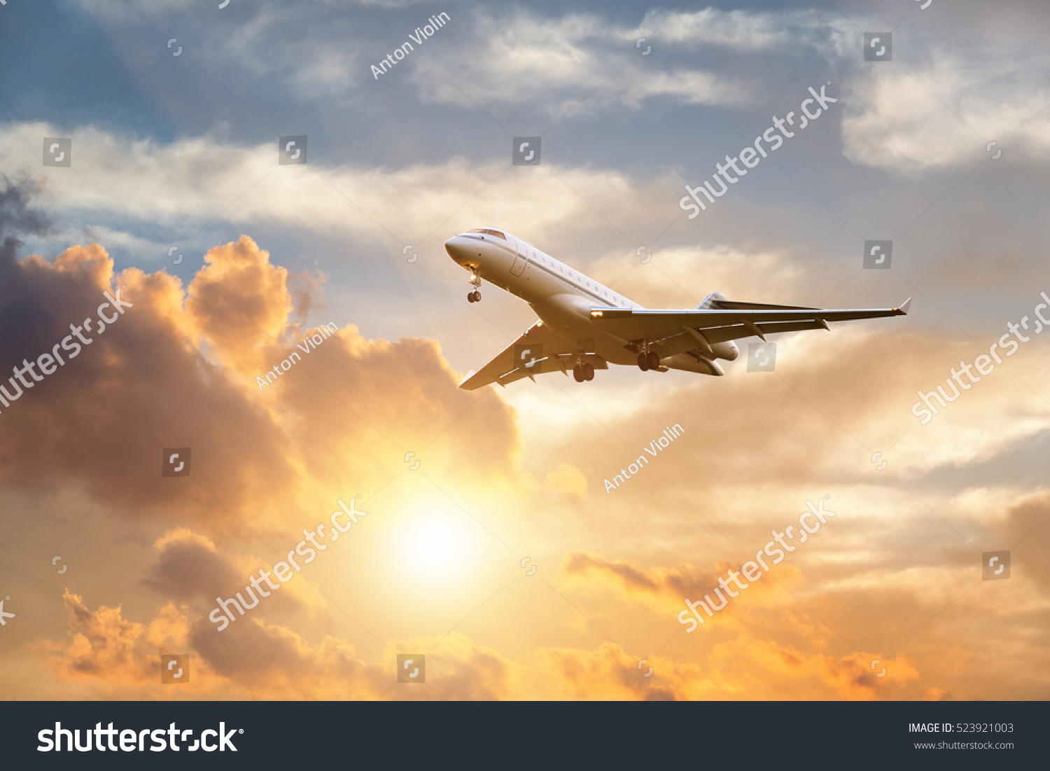 Commercial airplane landing at sunrise