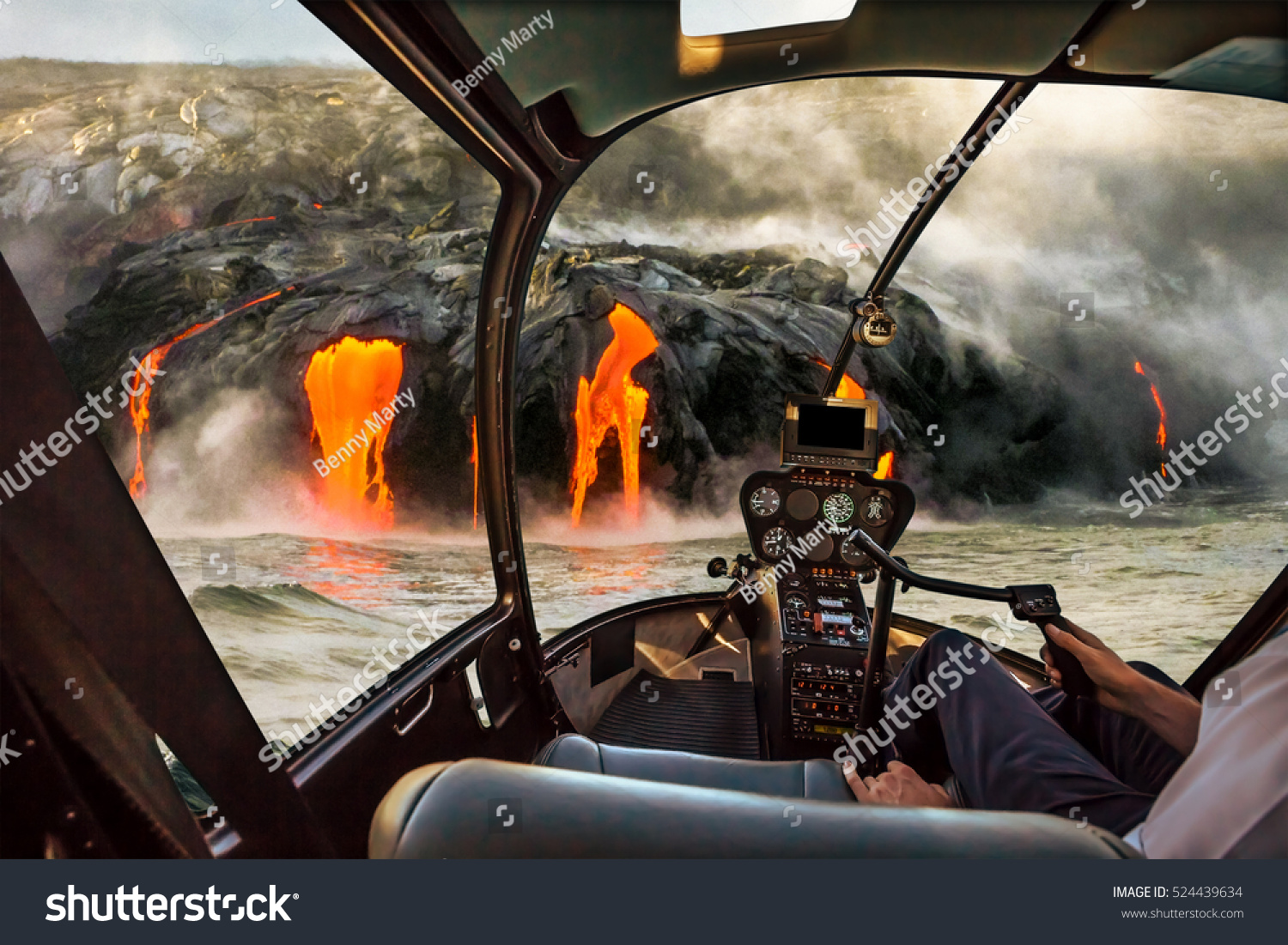 Helicopter cockpit flies in Kilauea Volcano  Big Island  Hawaii  United States by sunset  with pilot arm and control board inside the cabin.
