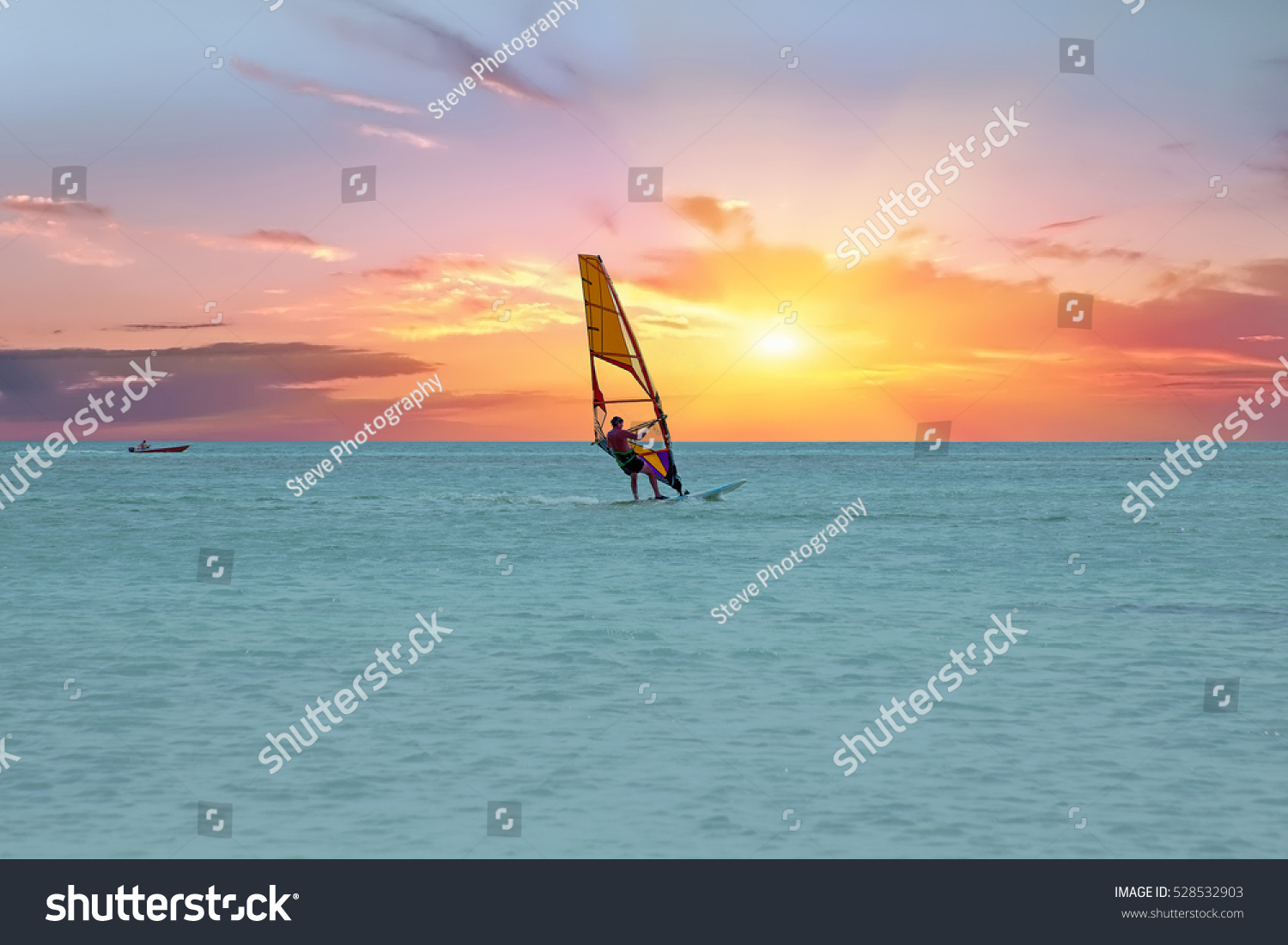 Windsurfer at Aruba island on the Caribbean Sea at a beautiful sunset