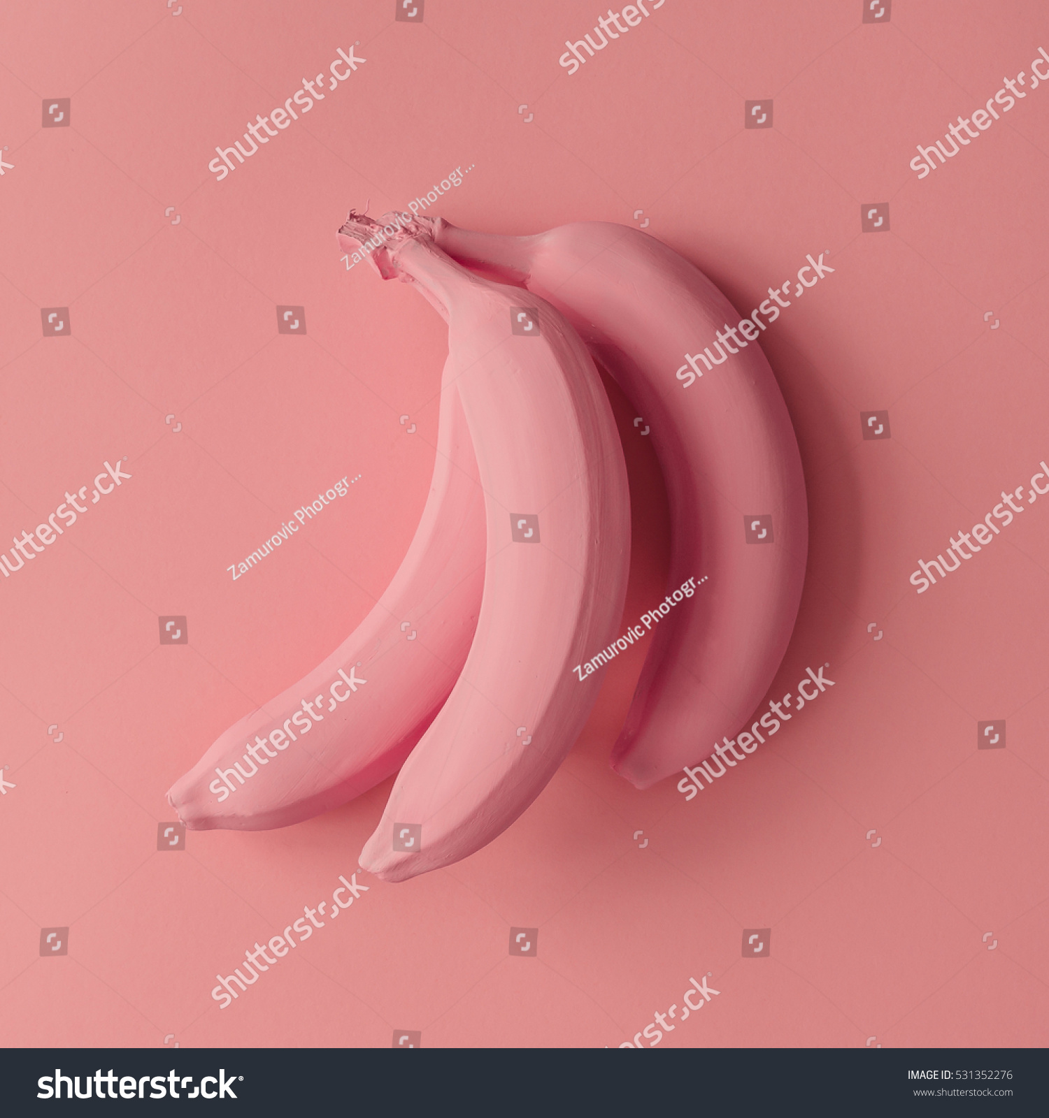 Pink bananas on pink background. Minimal style. Flat lay.