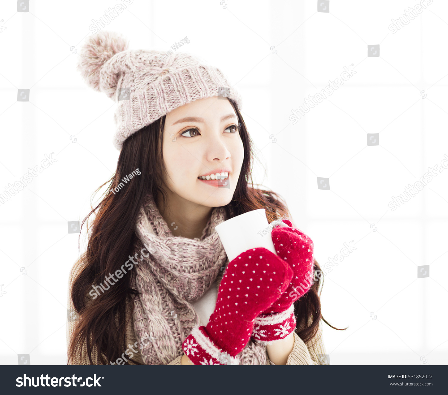 young Woman in winter clothes having hot drink