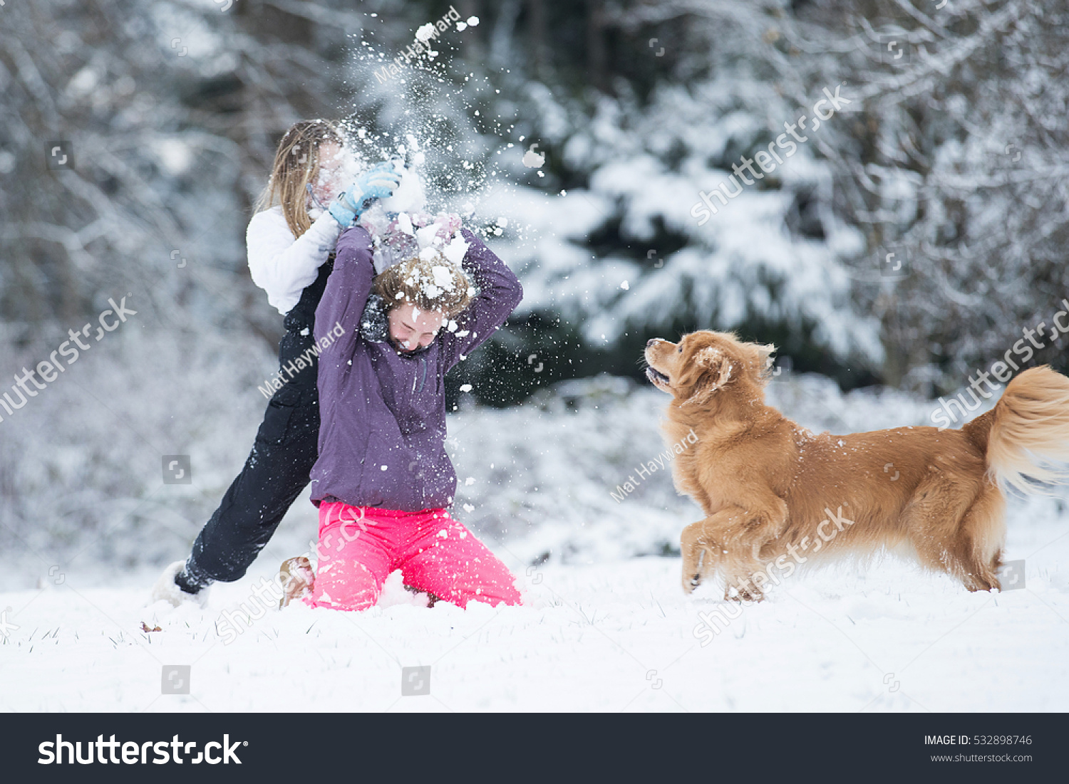 Child smashing snowball over another kids head during a white wi