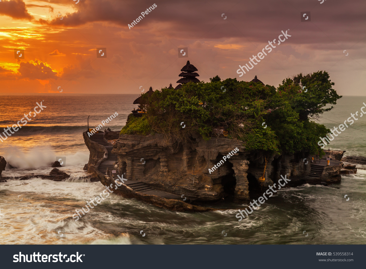 The Pilgrimage Temple of Pura Tanah Lot is perched dramatically on a large coastal rock.