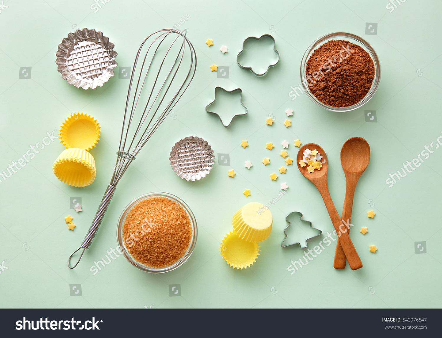 Dessert ingredients and utensils on green pastel background. Top view