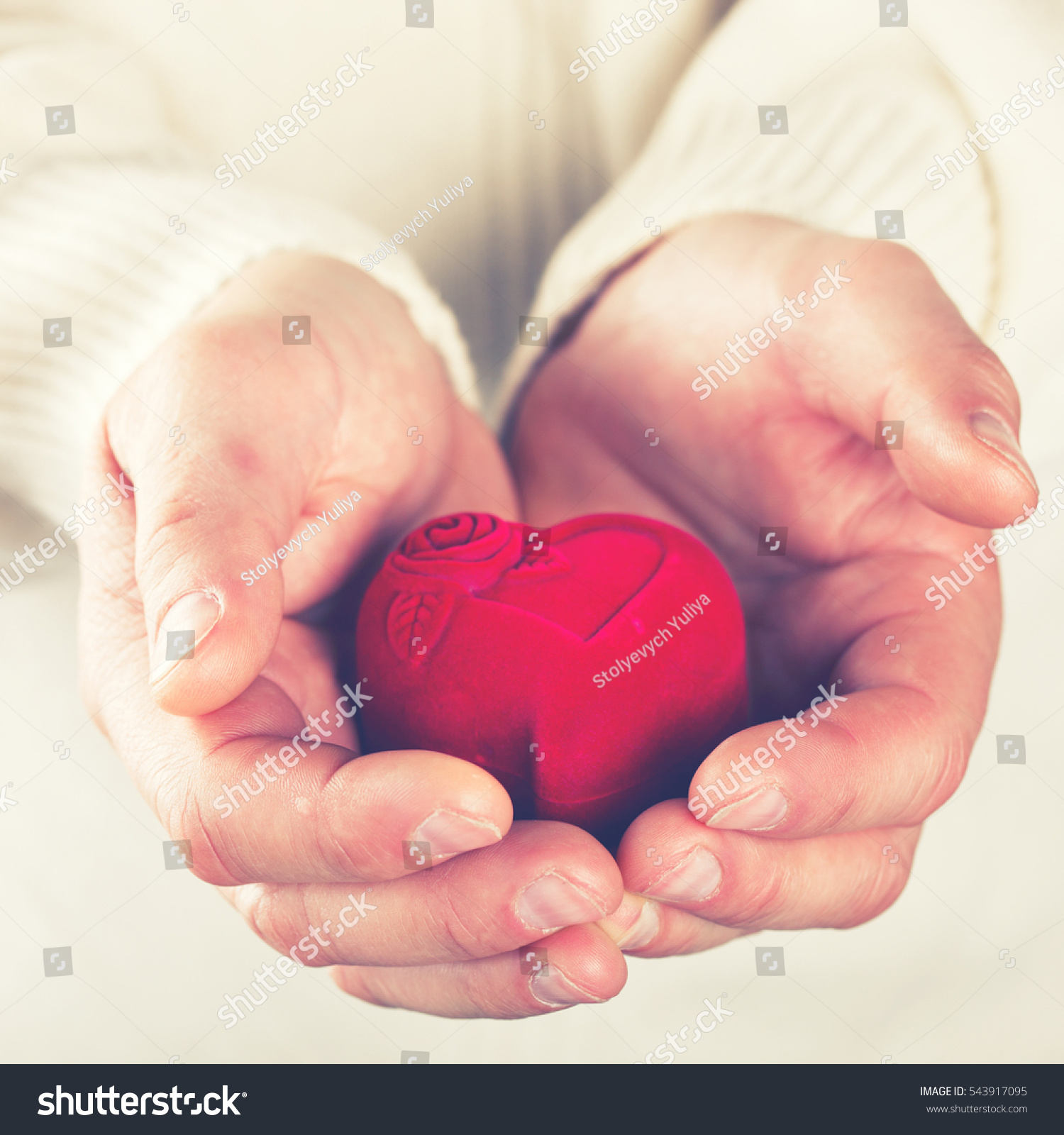 Heart Gift in the Hands of Men. Offer Love To A Woman.Holiday Valentine's Day.Wedding.toned image..selective focus.