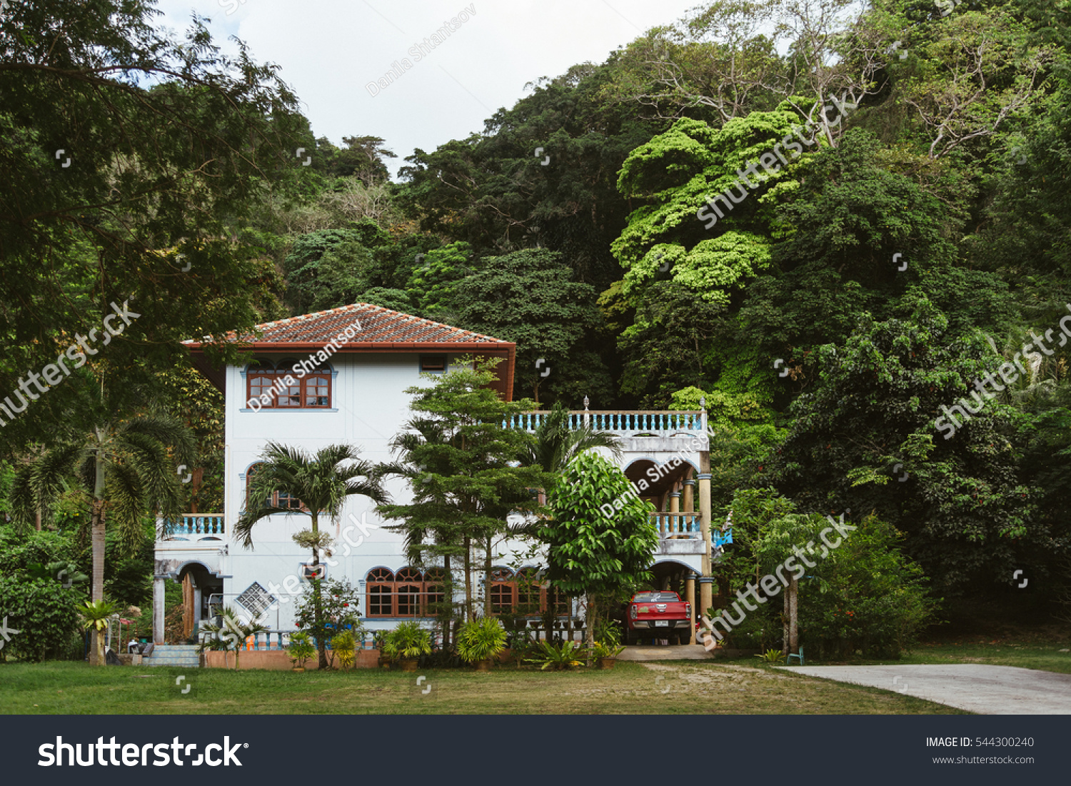A large house in the woods. 
