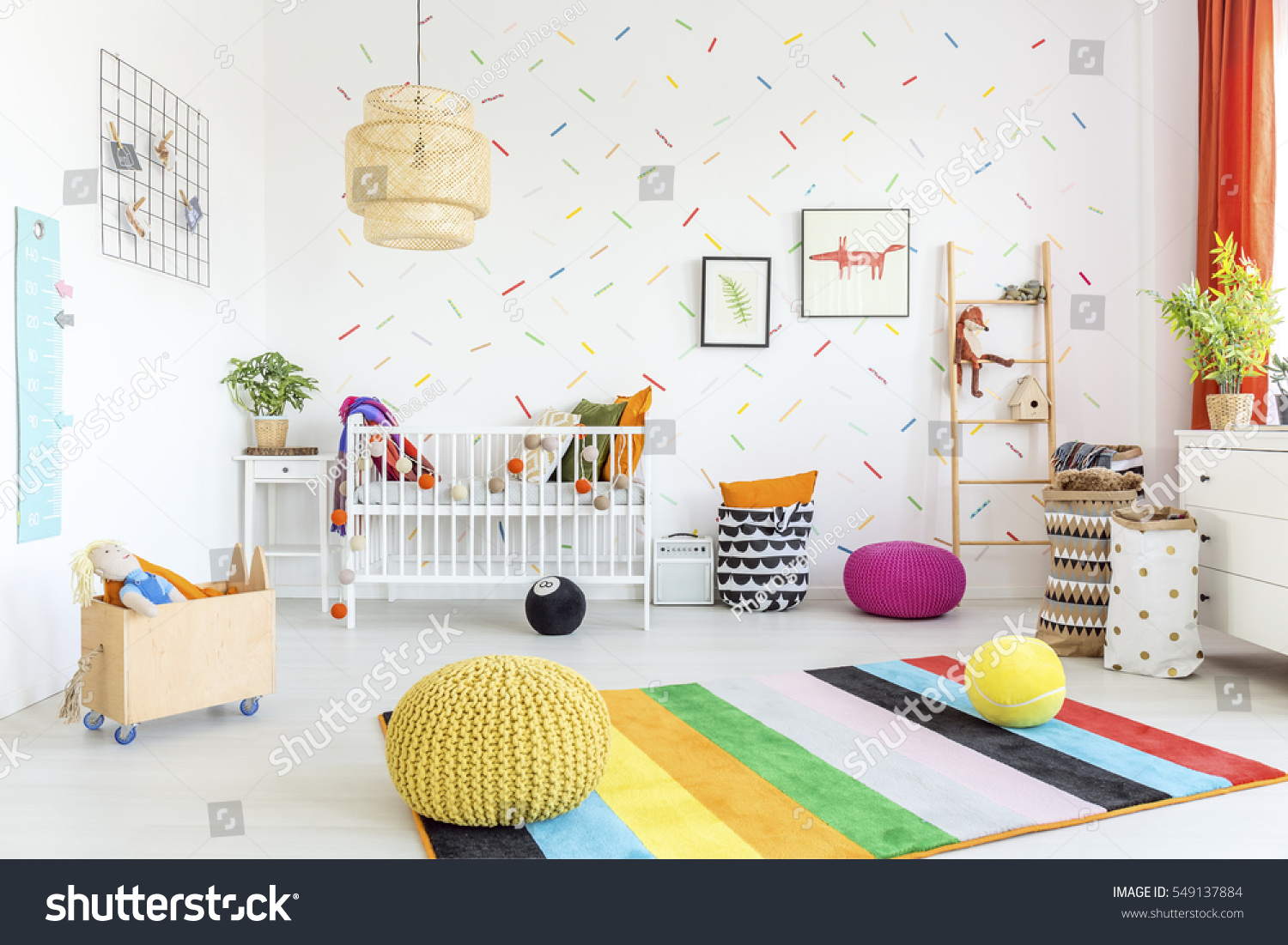 Baby room with white wall and light wooden furniture