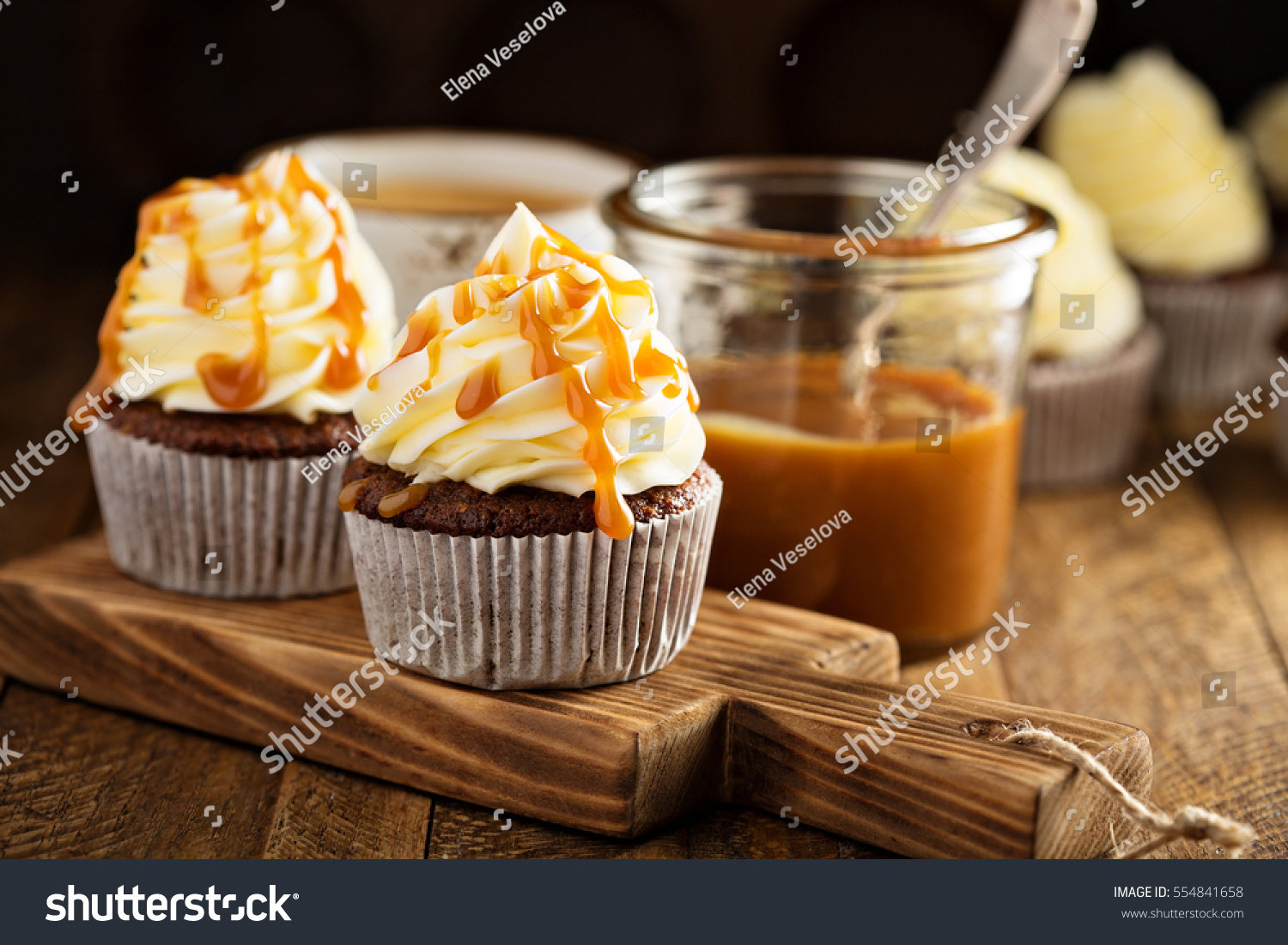 Homemade butterscotch cupcakes with caramel syrup and cream cheese frosting