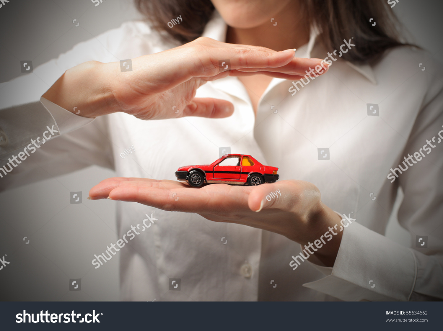 Woman holding the model of a car