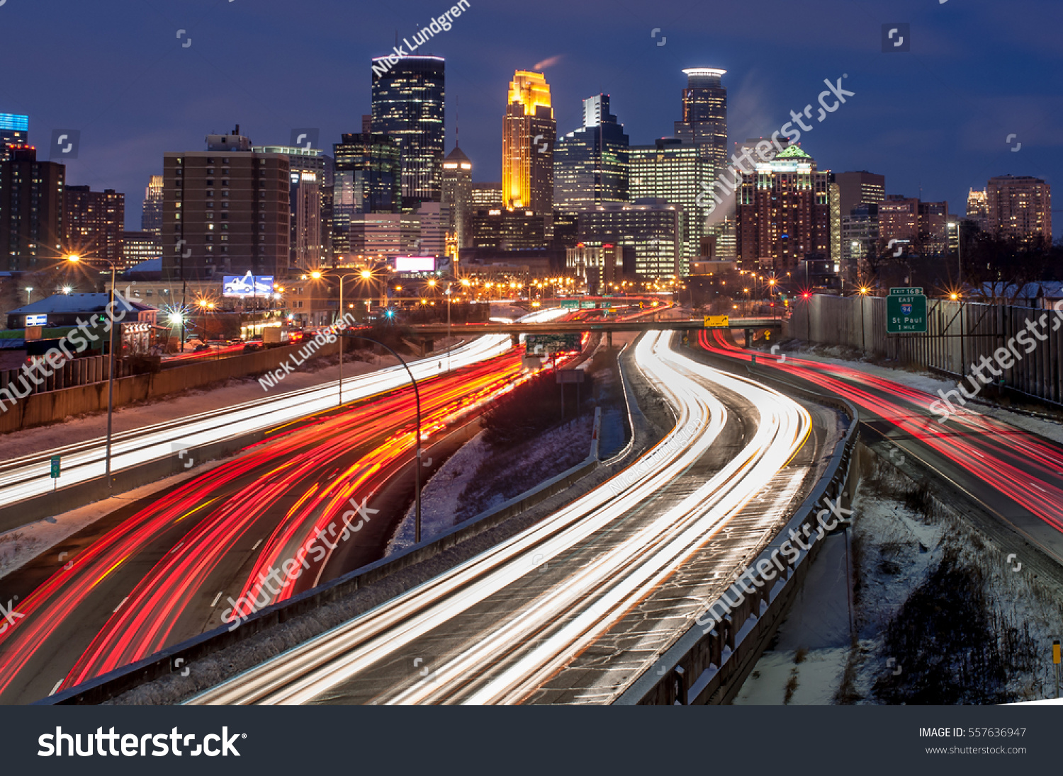 Heavy traffic flowing into Minneapolis on a busy winter evening.