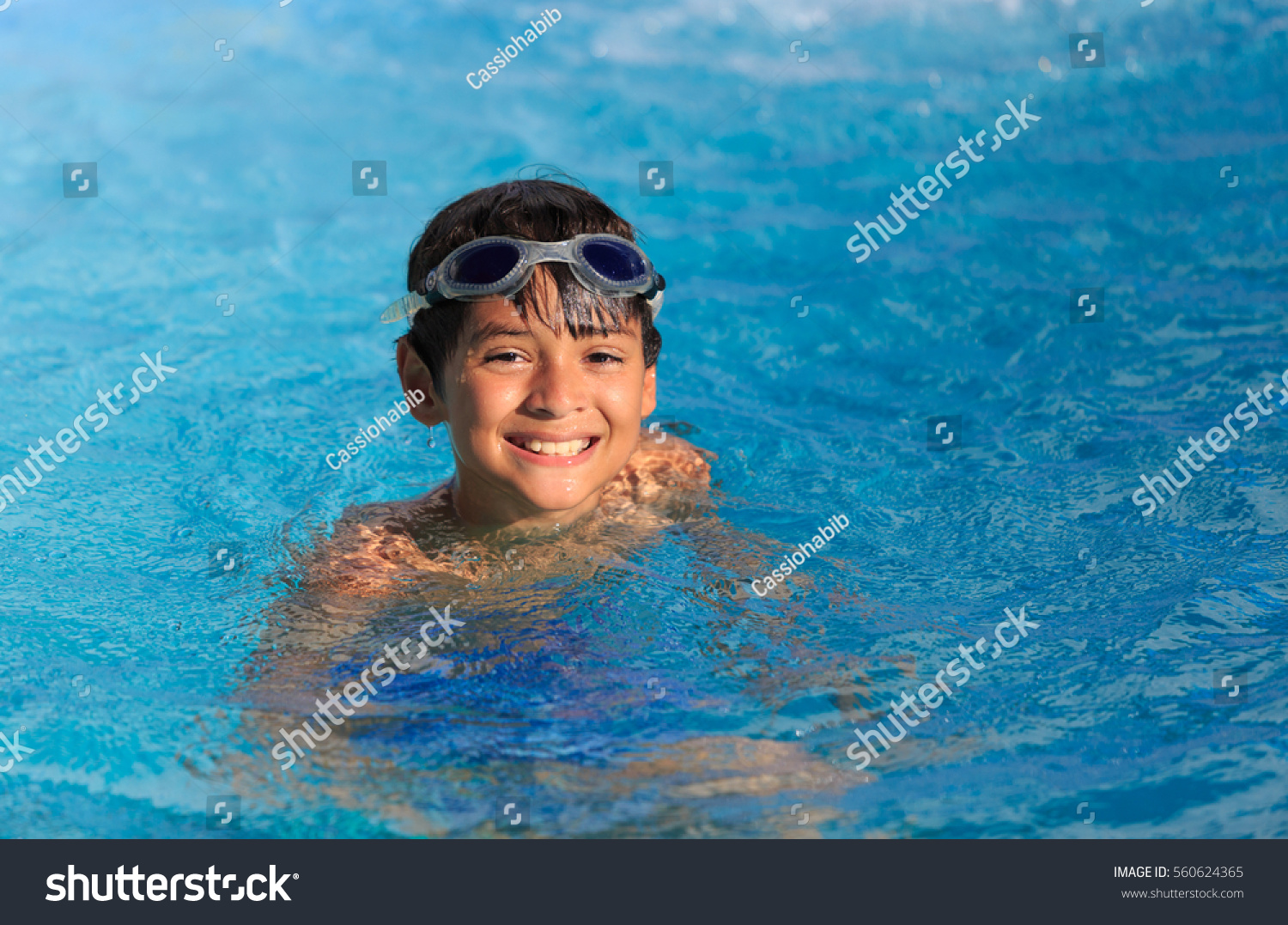 Boy swimming and playing in a pool