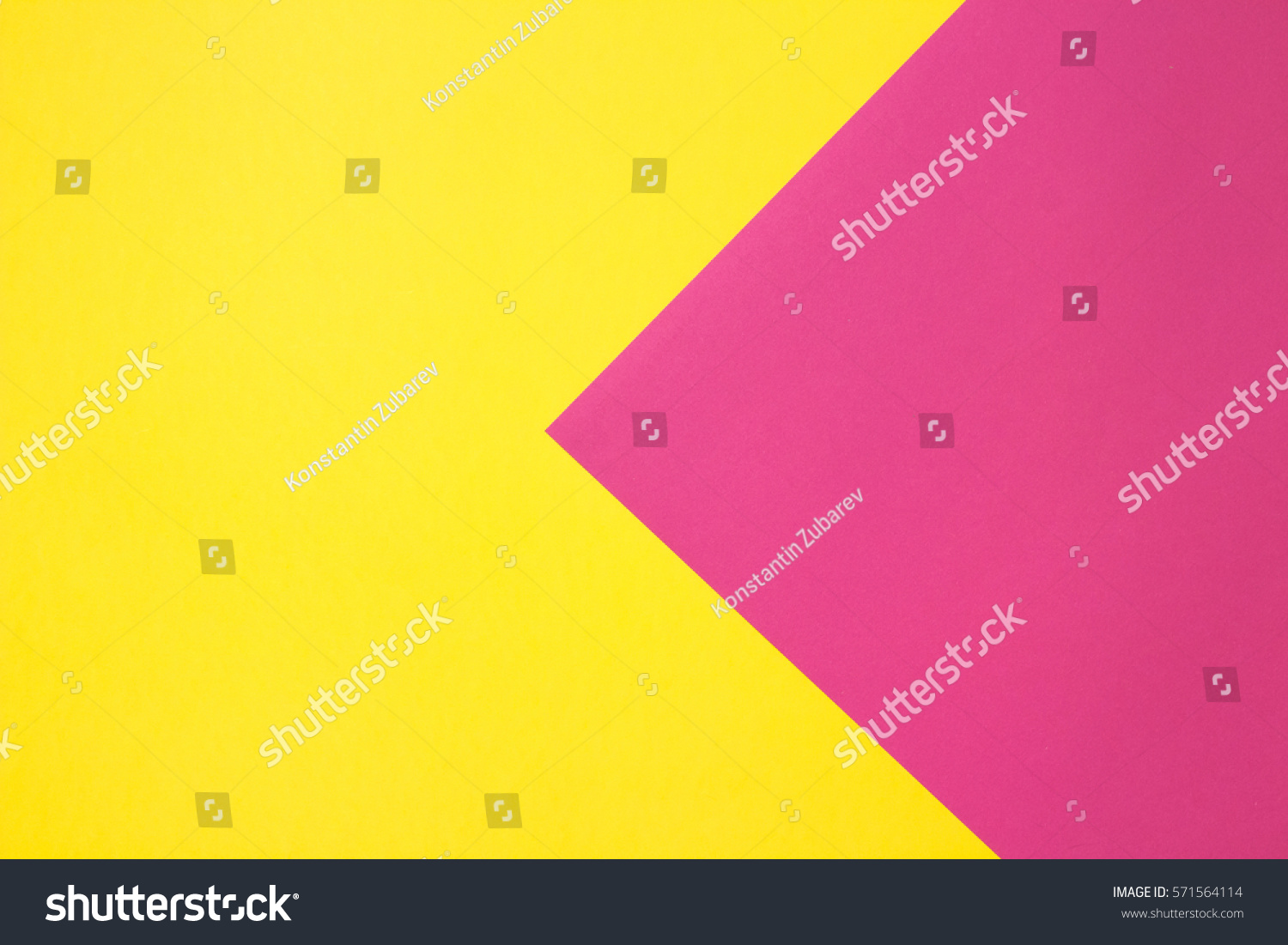 Coloured paper in geometric flat composition. Pink and yellow colors. Large arrow