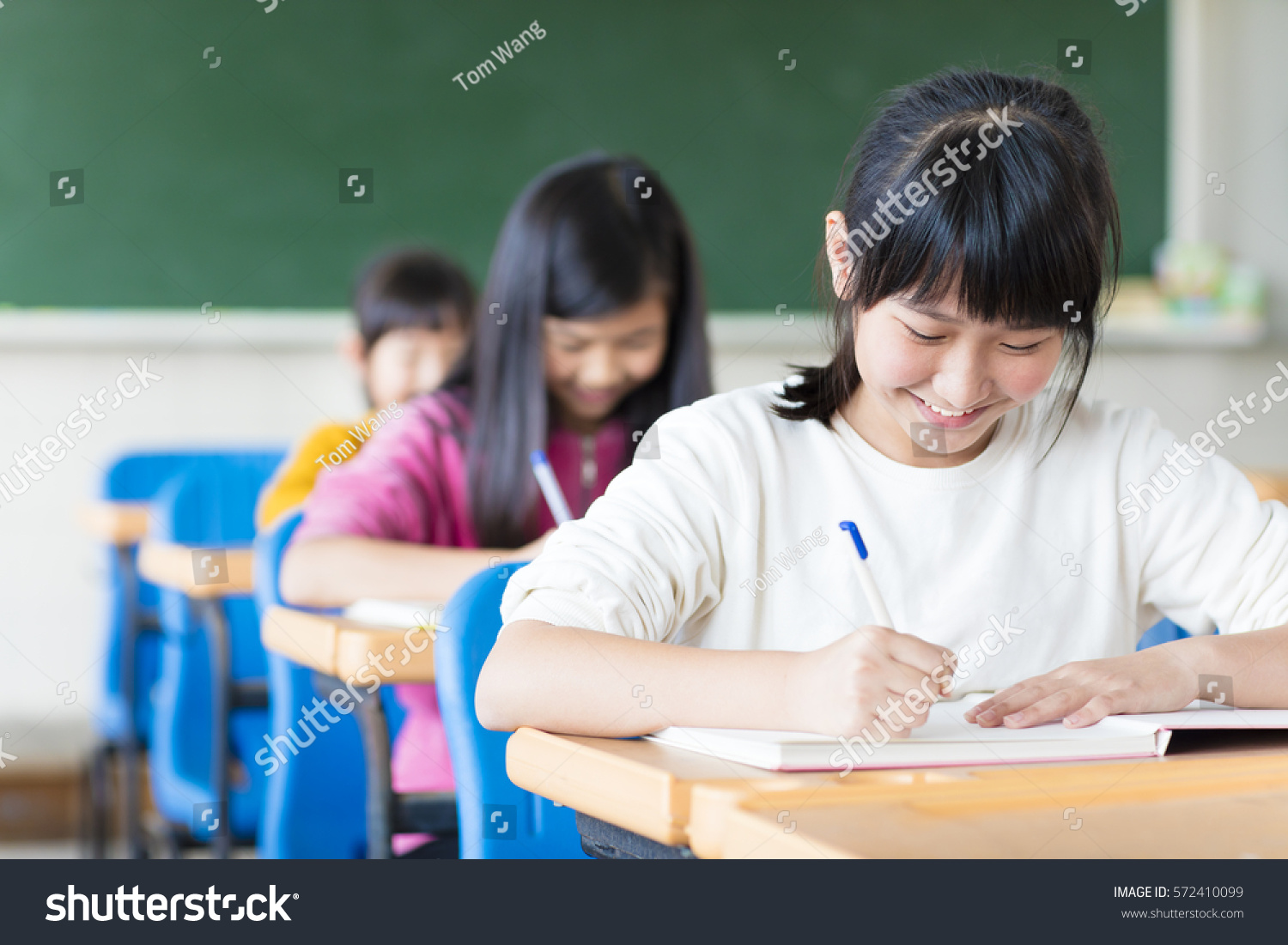happy teenager girl learning in the classroom