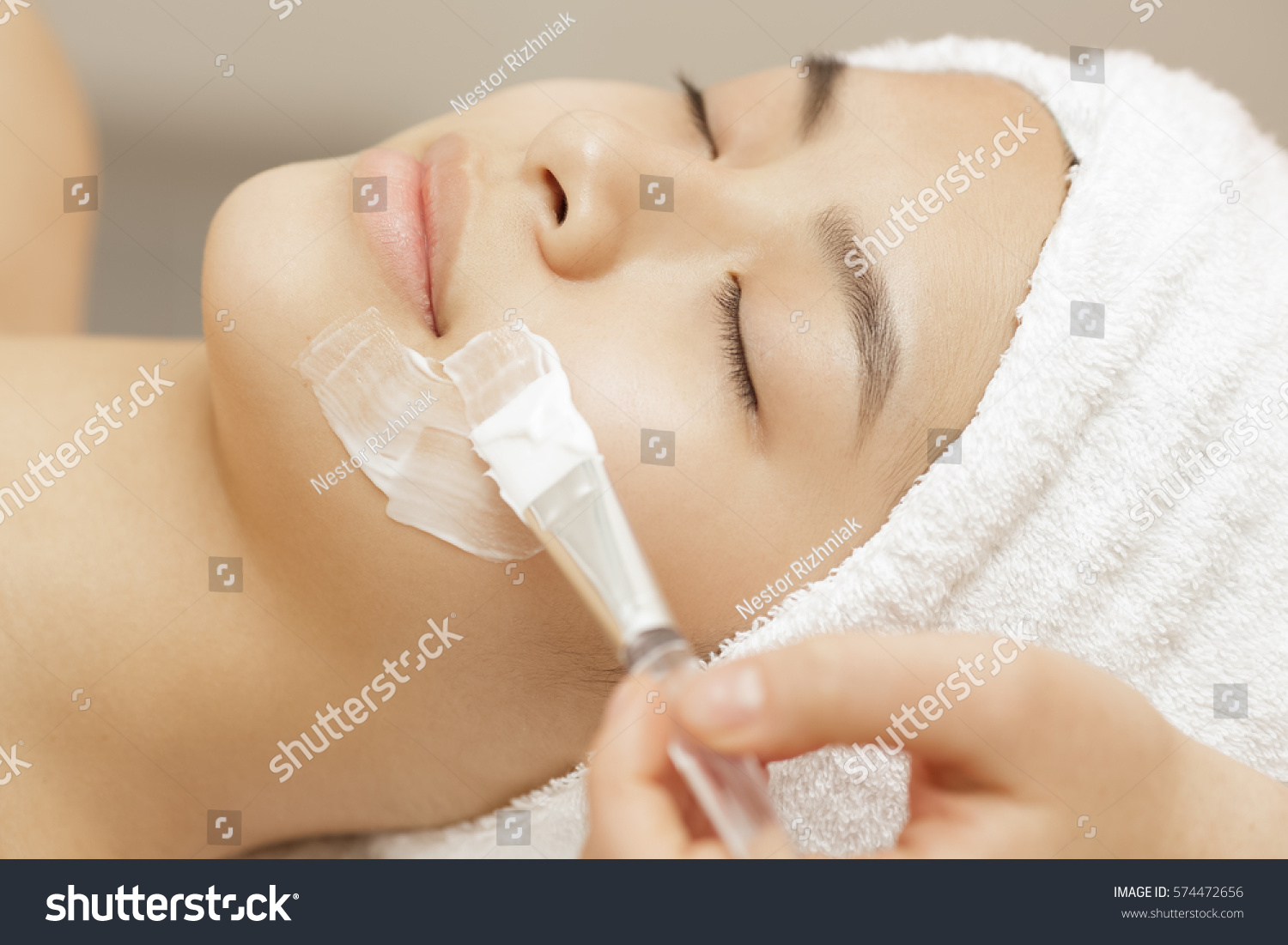Pampering for your skin. Close up of a beautiful Asian woman relaxing during spa facial treatment at the beauty center facial care mask skin recreation relaxation resort therapy treatment beauty 