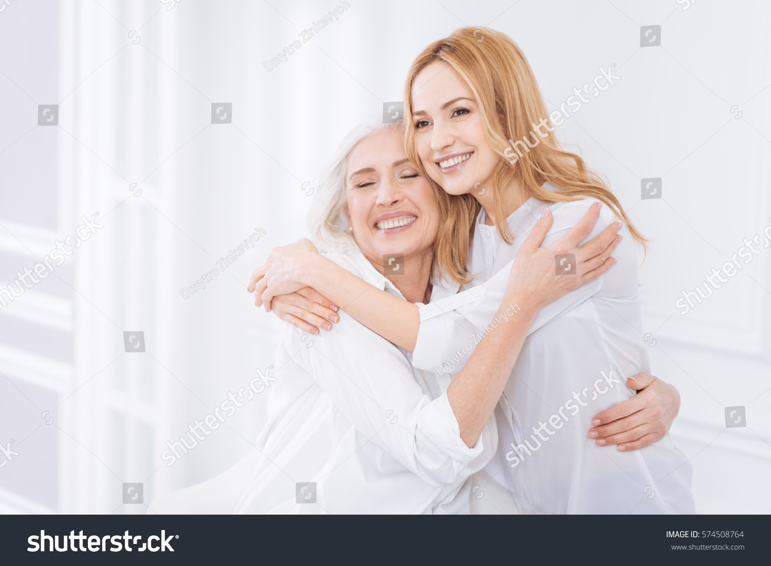 Pleasant woman and her mother embracing