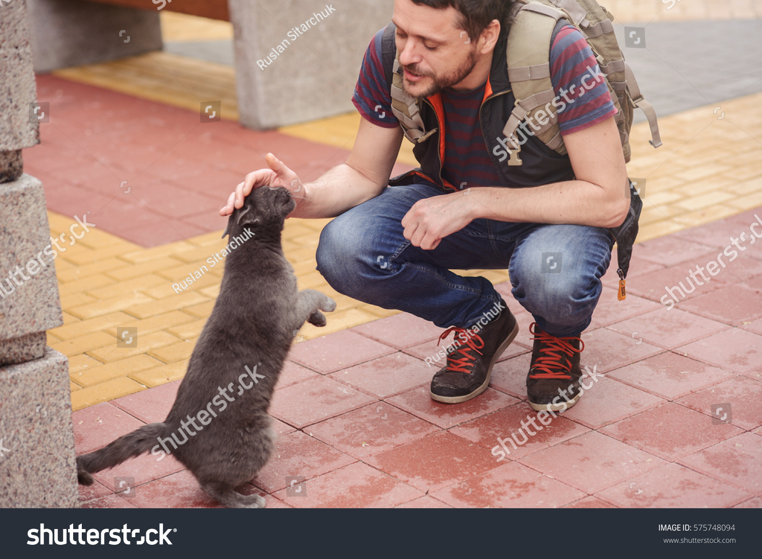 man walking with a cat in the city in the bright day  mild toning