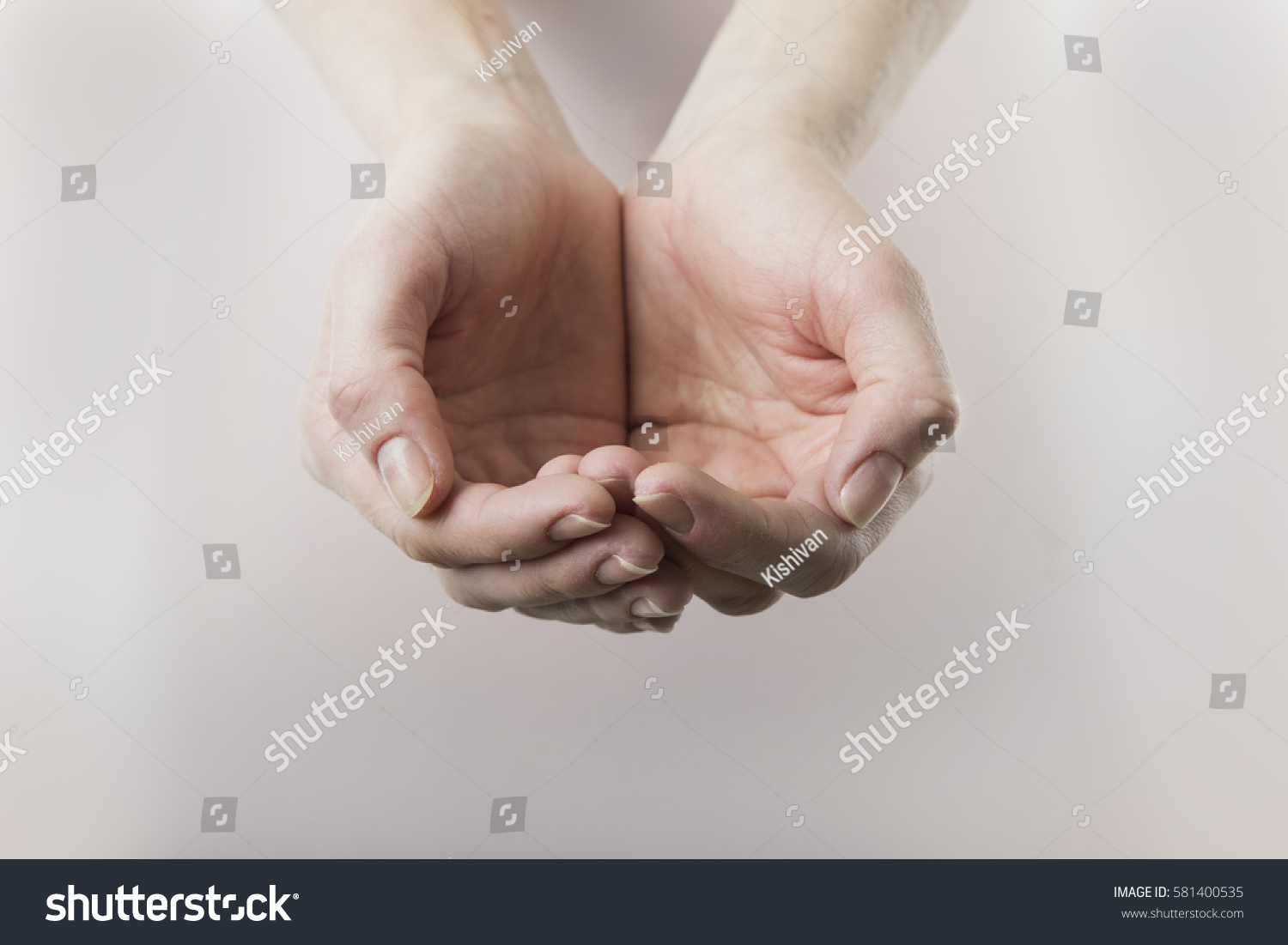 close up of womans cupped hands showing something