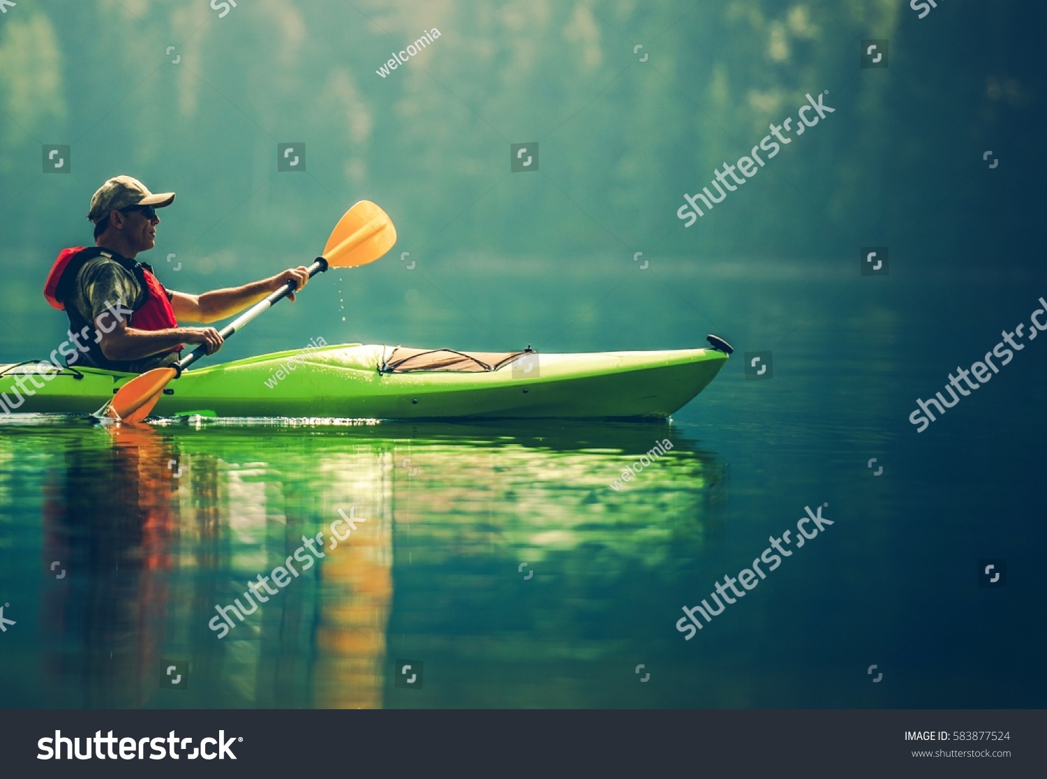 Senior Kayaker on the Lake. Kayak Paddling. Water Sport and Recreation.