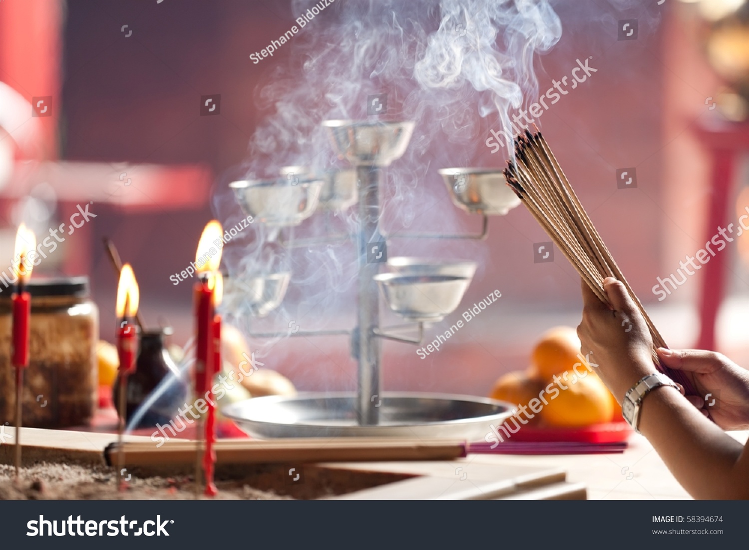 woman offering smoking incense in chinese temple  Kuala Lumpur  Malaysia
