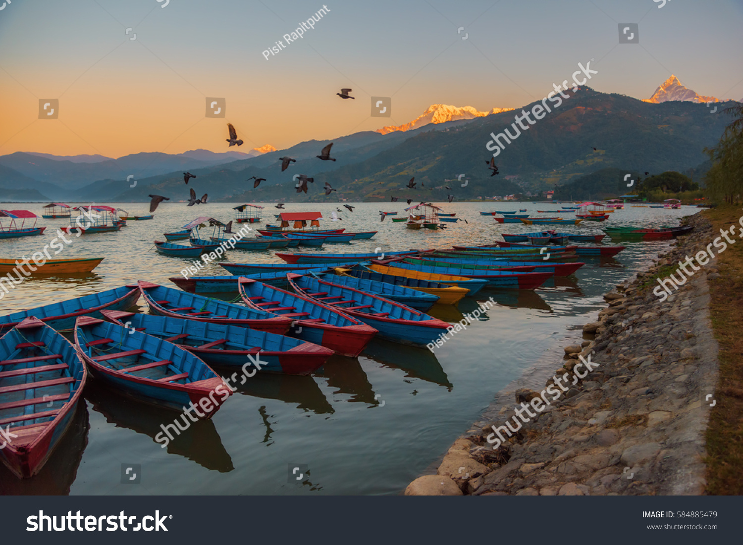 Sunrise with wooden boats on Phewa lake  Pokhara  Nepal.