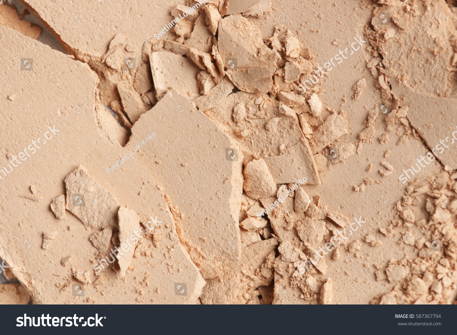 Broken and messy facial compact powder close-up texture. Shallow DOF.