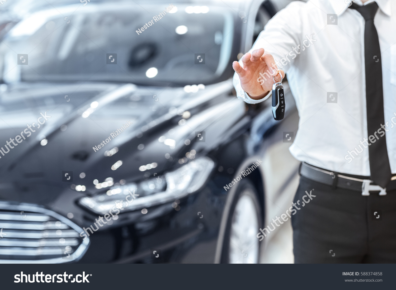 Passing car keys. Cropped closeup of a car dealer holding out car keys to the camera copyspace car dealership salon manager salesman selling buying giving owner profession purchase vehicle concept