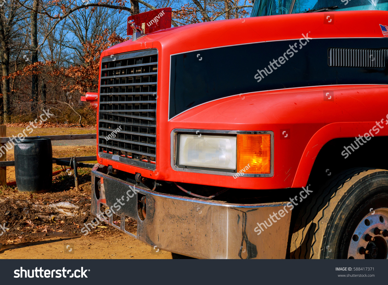 front end of a semi truck while parked red truck